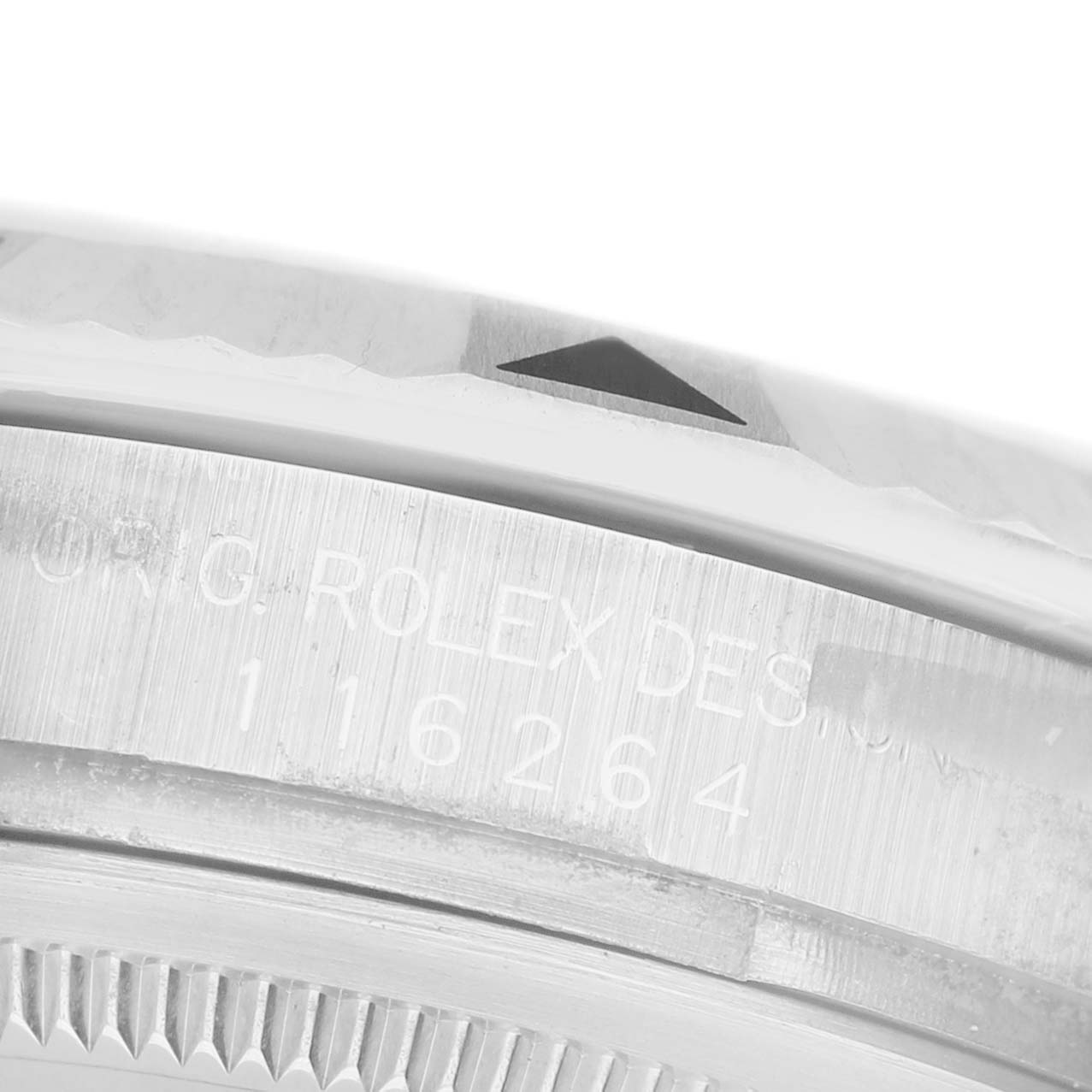 The image shows a close-up of the side of the Rolex Turn-o-Graph 116264 Men's Stainless Steel Black Dial's bezel and case, highlighting the engraved text and a portion of the fluted bezel.