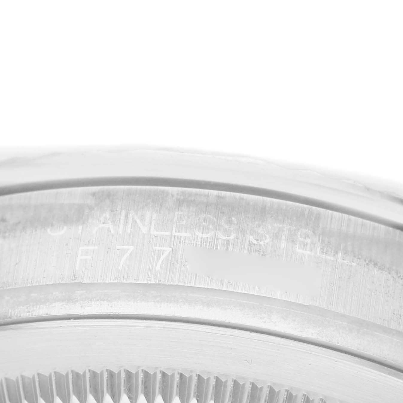 The image shows a close-up of the stainless steel case back and fluted bezel of a Rolex Turn-o-Graph 116264 Men's Stainless Steel Black Dial watch.
