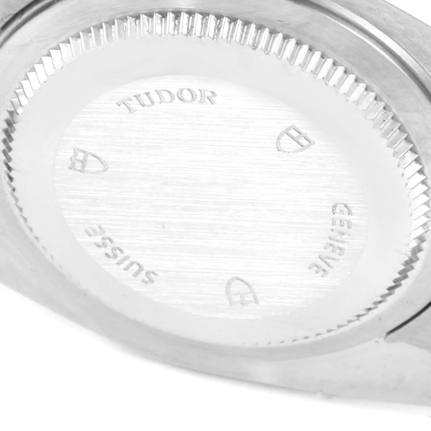 The image shows the case back of a Classic model by Tudor, captured from an oblique angle.