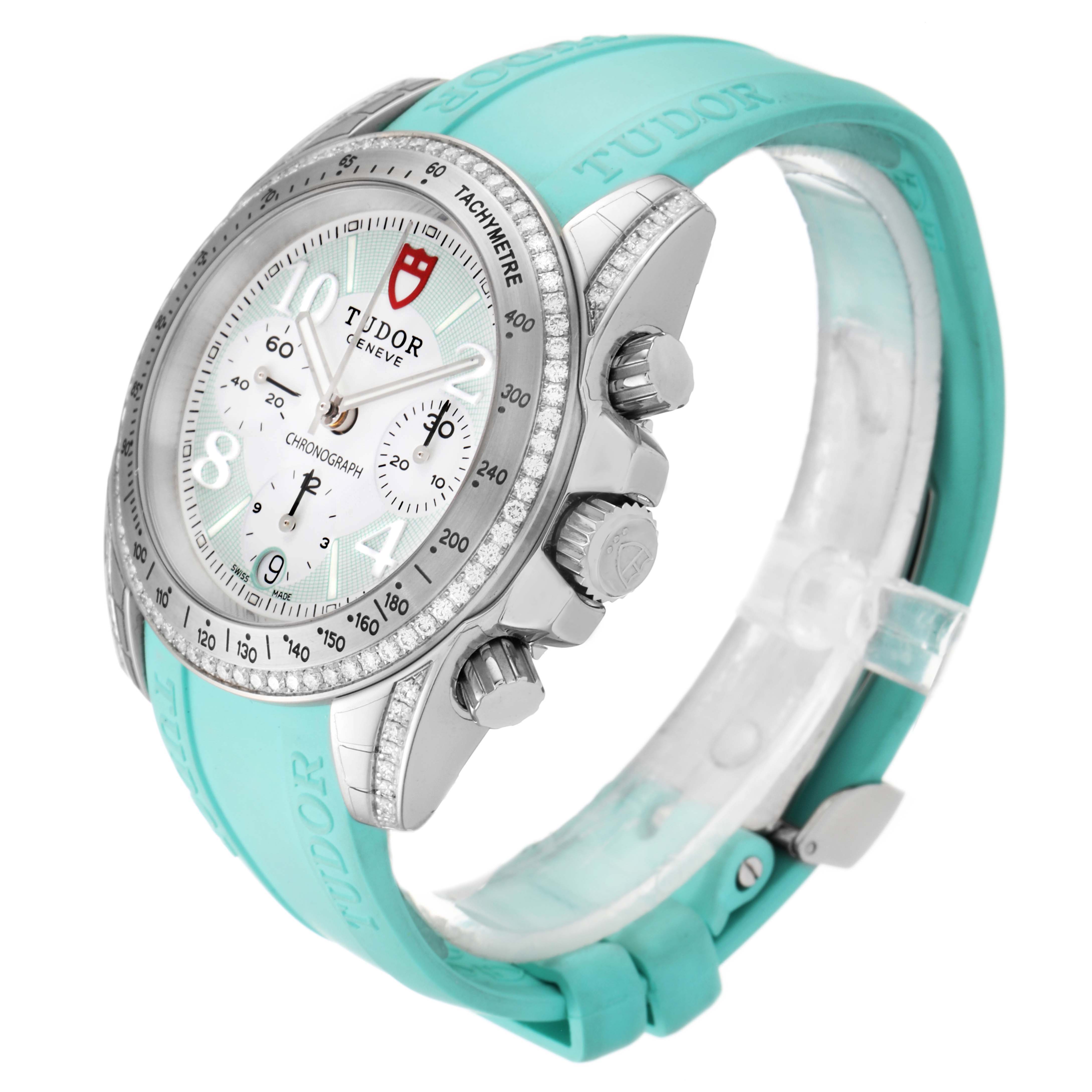 The Tudor Grantour 20310 Men
s Stainless Steel White Dial 20310 Men
s Stainless Steel White Dial watch is shown at an angled side view, highlighting its dial, chronograph pushers, and turquoise strap.