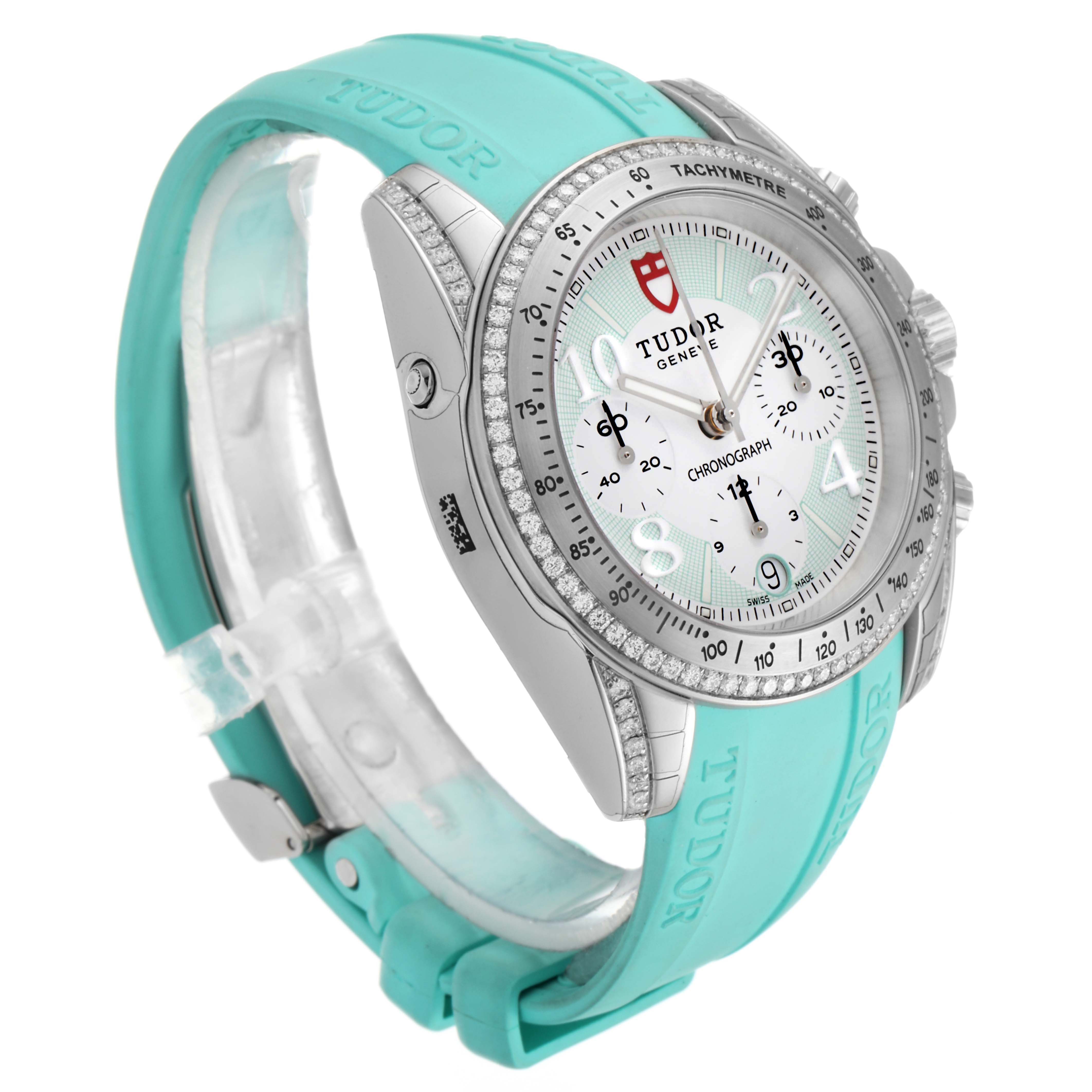 The image shows a side angle view of the Tudor Grantour 20310 Men
s Stainless Steel White Dial 20310 Men
s Stainless Steel White Dial watch, featuring its dial, bezel, and turquoise strap.