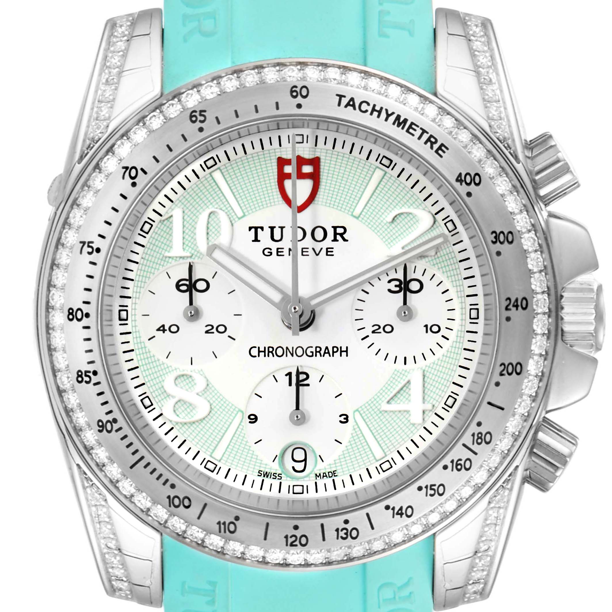 The image shows a front view of the Tudor Grantour 20310 Men
s Stainless Steel White Dial 20310 Men
s Stainless Steel White Dial watch, displaying the dial, bezel, tachymeter, subdials, and part of the turquoise strap.