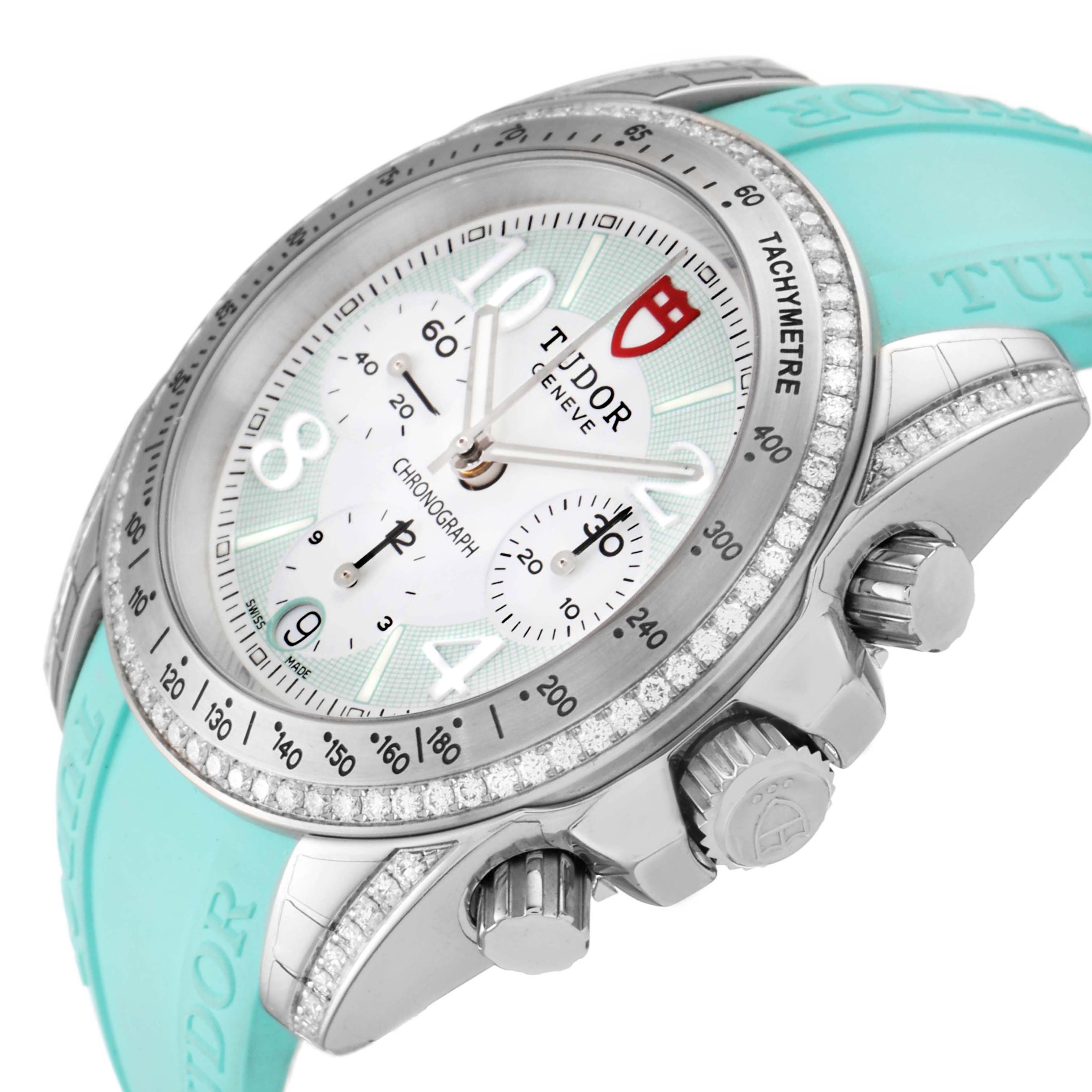 The image shows a close-up of the Tudor Grantour 20310 Men
s Stainless Steel White Dial 20310 Men
s Stainless Steel White Dial watch face, crown, and tachymeter bezel at an angle, with a turquoise strap.