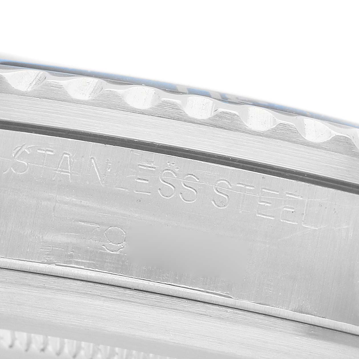 The image shows a side view with an engraving on the stainless steel case of the Tudor Submariner 9411 Men's Stainless Steel Blue Dial watch.