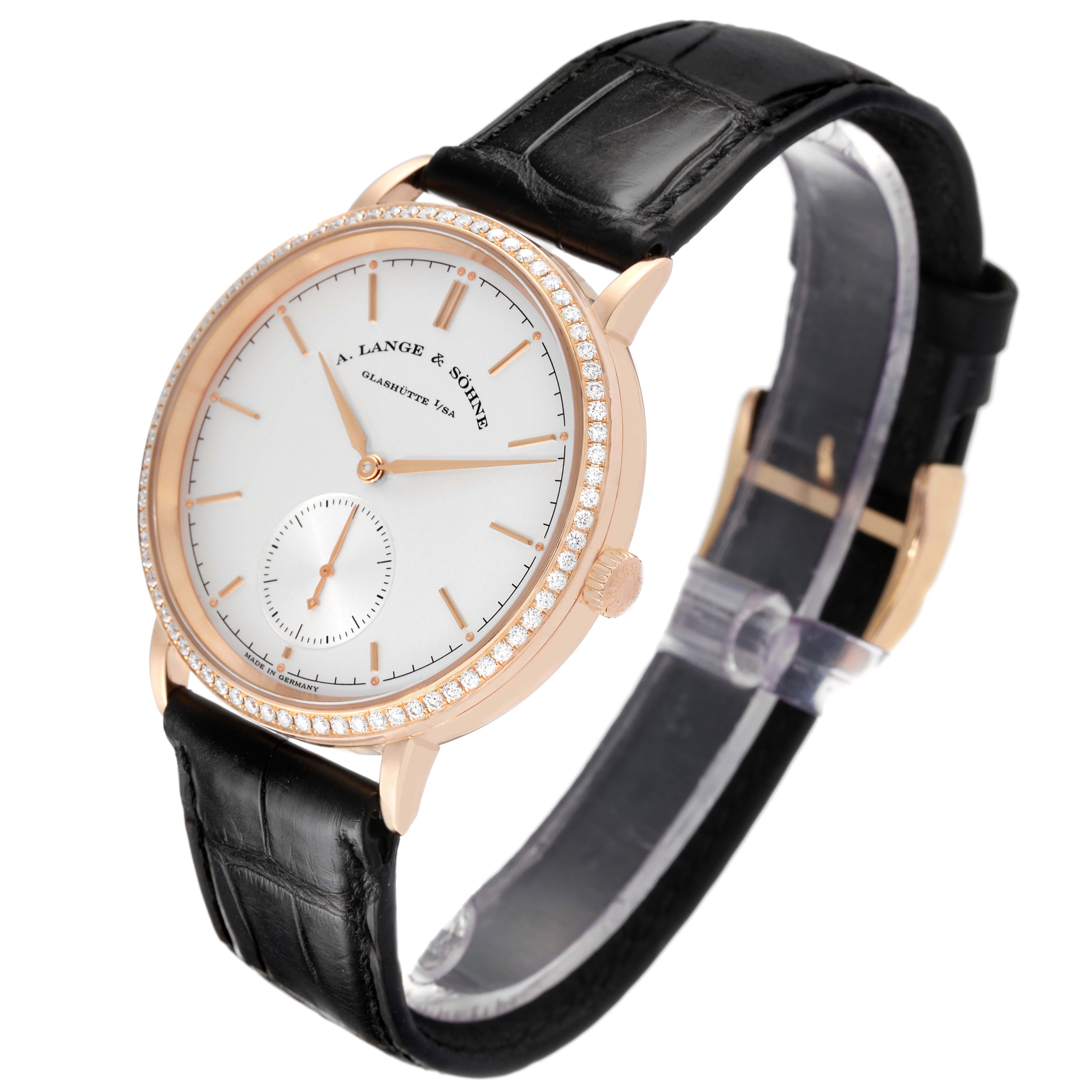 The A. Lange & Sohne Saxonia 842.032 Men's Rose Gold Silver Dial watch is shown at an angled side view, displaying the face, bezel, crown, and strap.