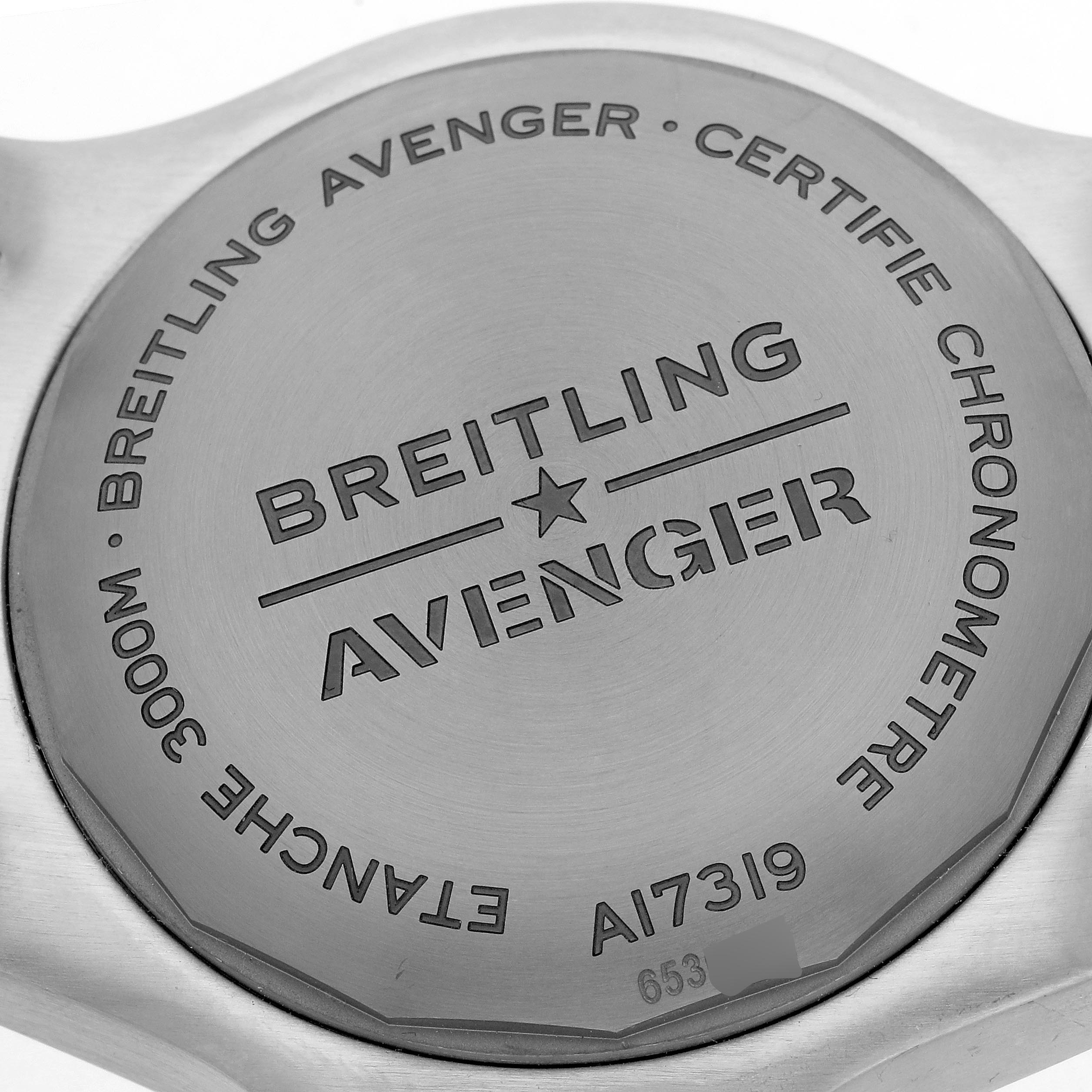 The image shows the back case of a Breitling Avenger A17319 Men's Stainless Steel Yellow Dial A17319 Men's Stainless Steel Yellow Dial watch, featuring engraved branding and specifications.