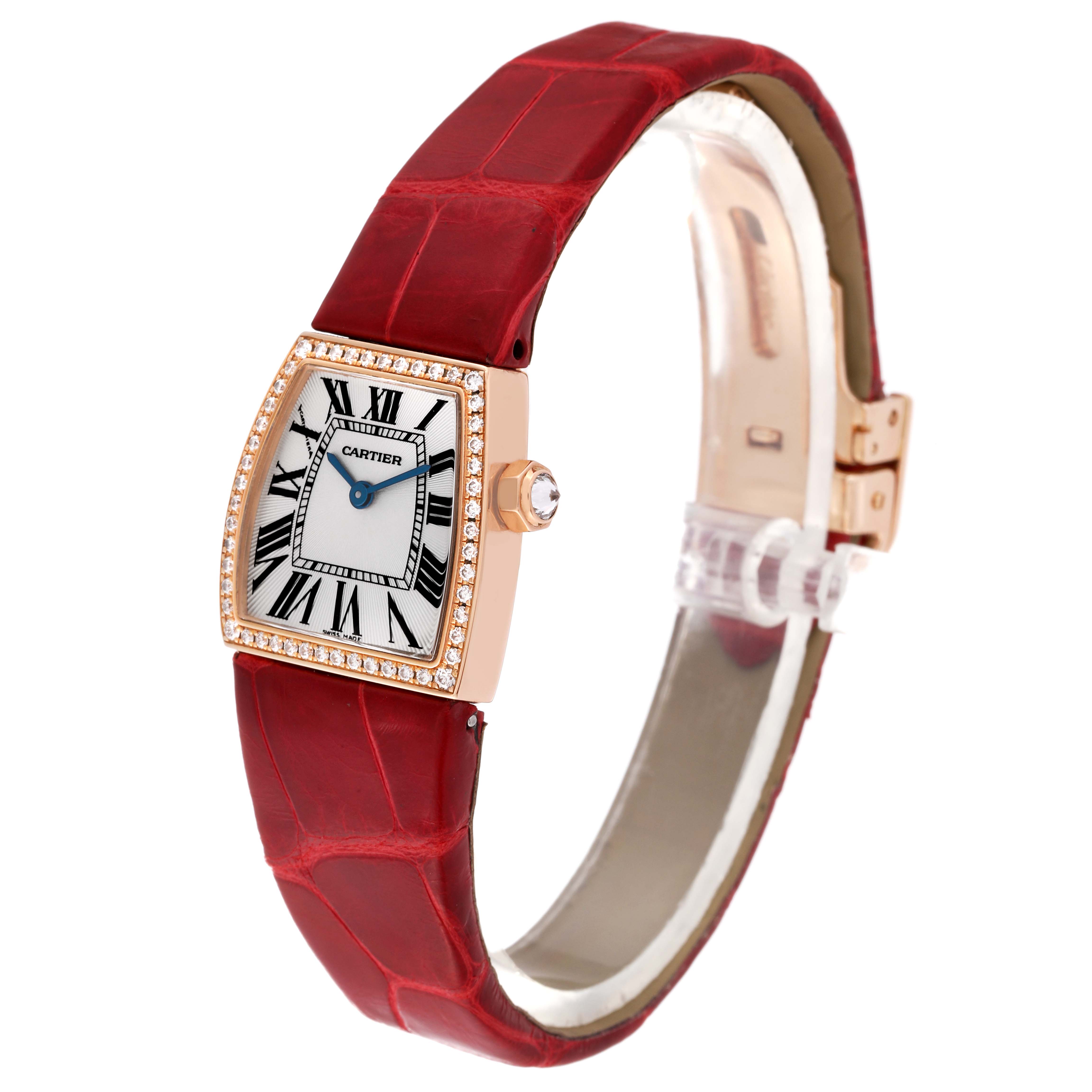 The image shows a side angle of the Cartier La Dona WE600651 Women's Rose Gold Silver Dial WE600651 Women's Rose Gold Silver Dial watch, highlighting the red strap, diamond-studded bezel, and the face with Roman numerals.
