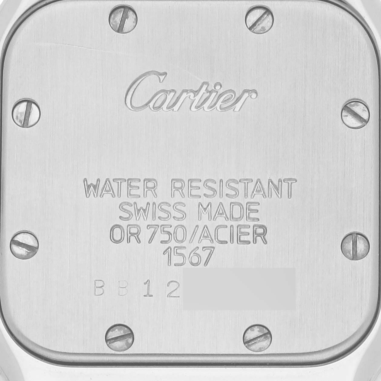 The image shows the back case of a Santos model by Cartier, highlighting its inscriptions and screws.