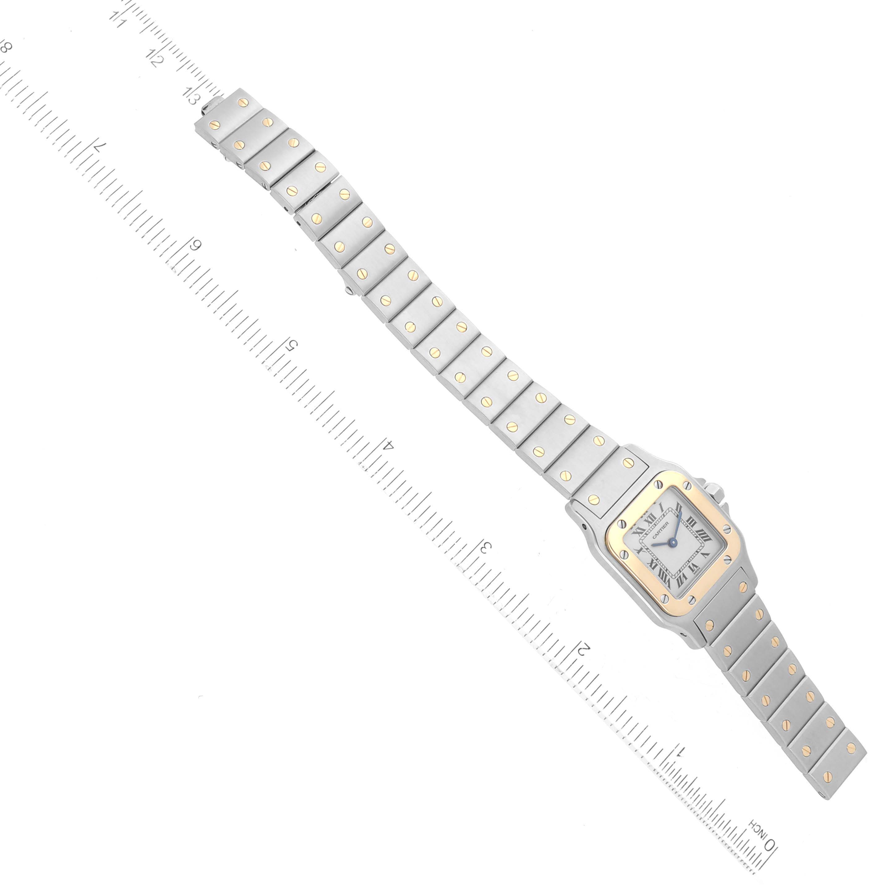 The image shows a top-down view of the Santos model watch by Cartier, displaying its face and full bracelet.