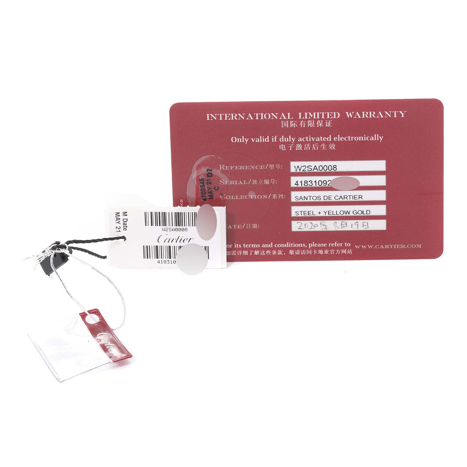The image shows the warranty card, tags, and accessories for a Santos de Cartier watch.