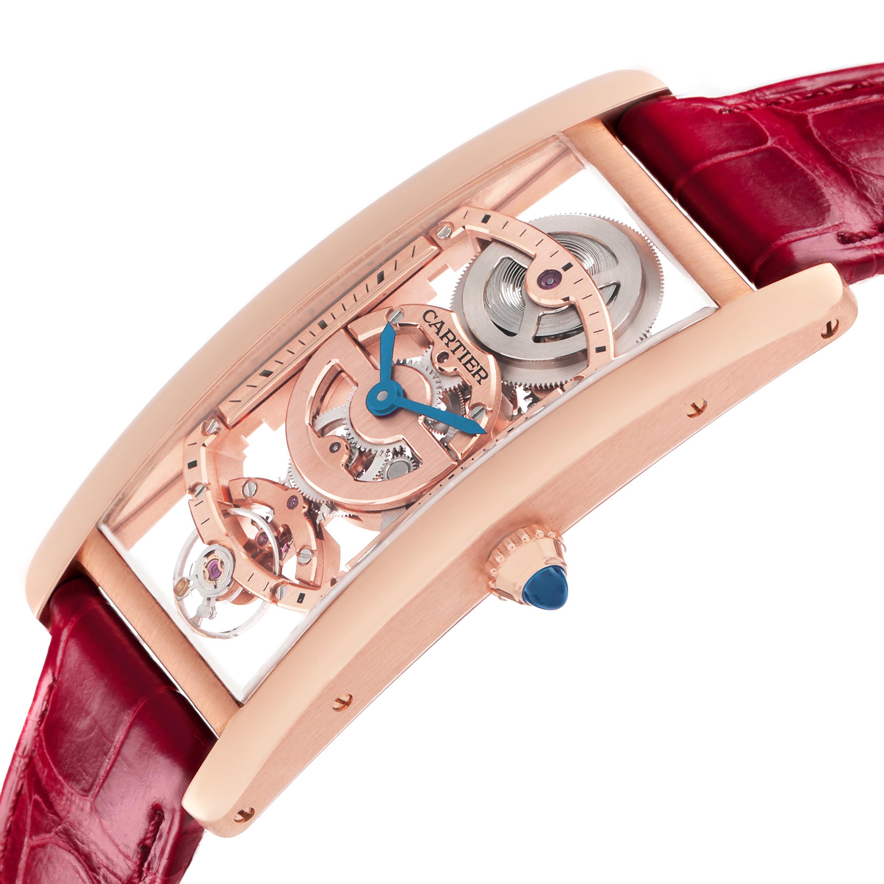 The Cartier Tank Cintrée watch is shown from a side angle, highlighting its rose gold case, open-worked dial, gears, and red strap.