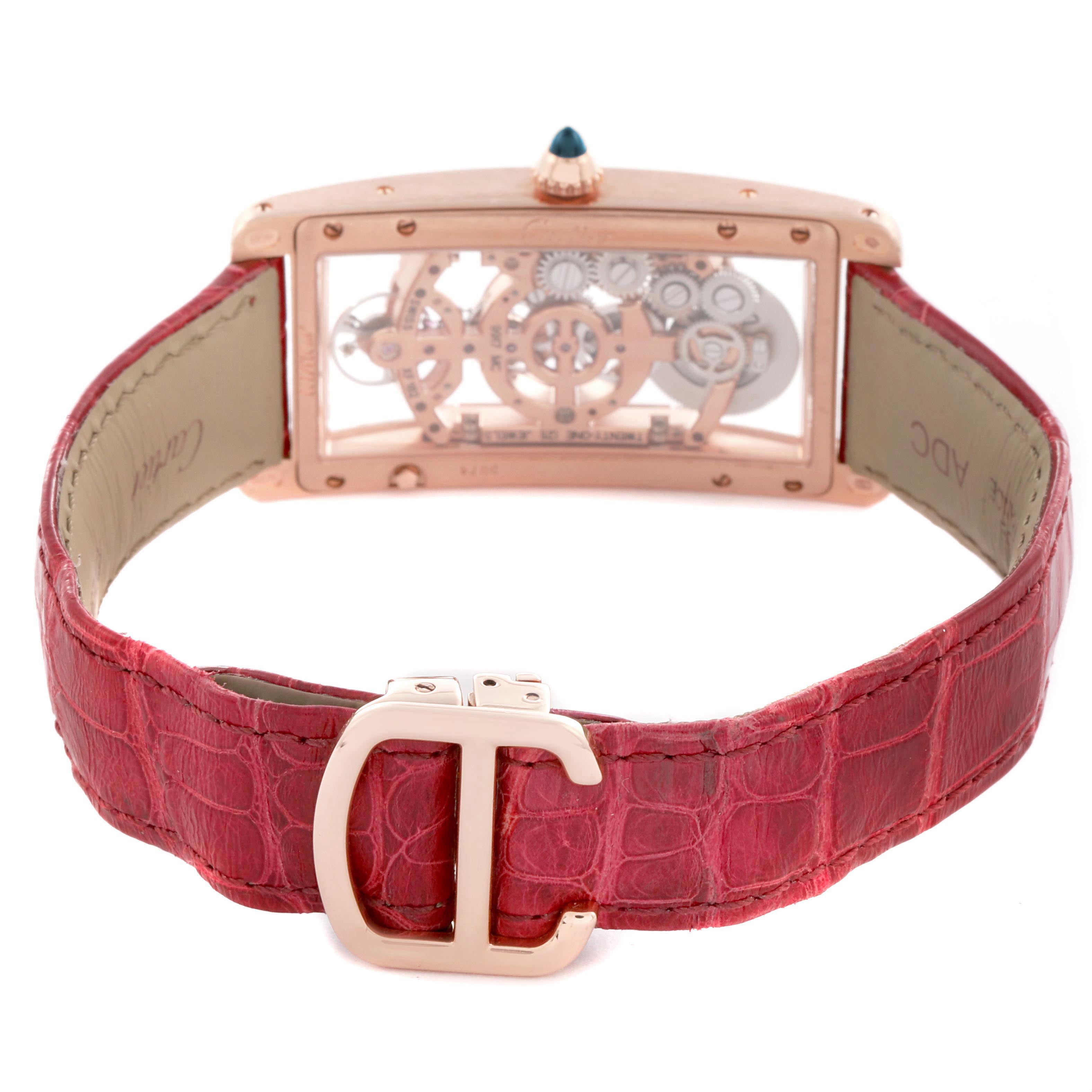 The Cartier Tank Cintrée is shown from the back, highlighting its exposed mechanical movement and red leather strap.