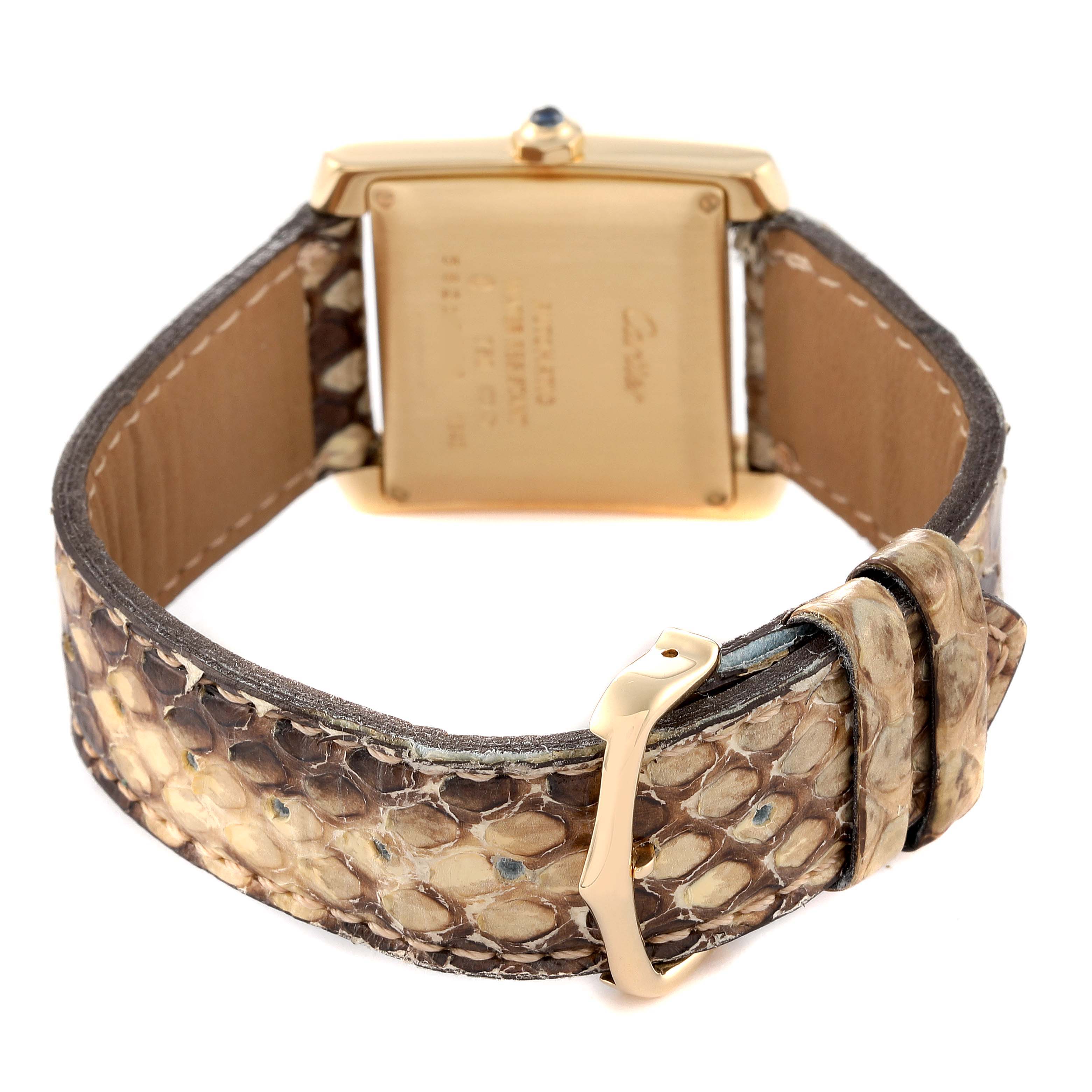 The image shows the back view of a Cartier Tank Francaise W5000156 Men's Yellow Gold Silver Dial W5000156 Men's Yellow Gold Silver Dial watch with a snakeskin strap and gold buckle.