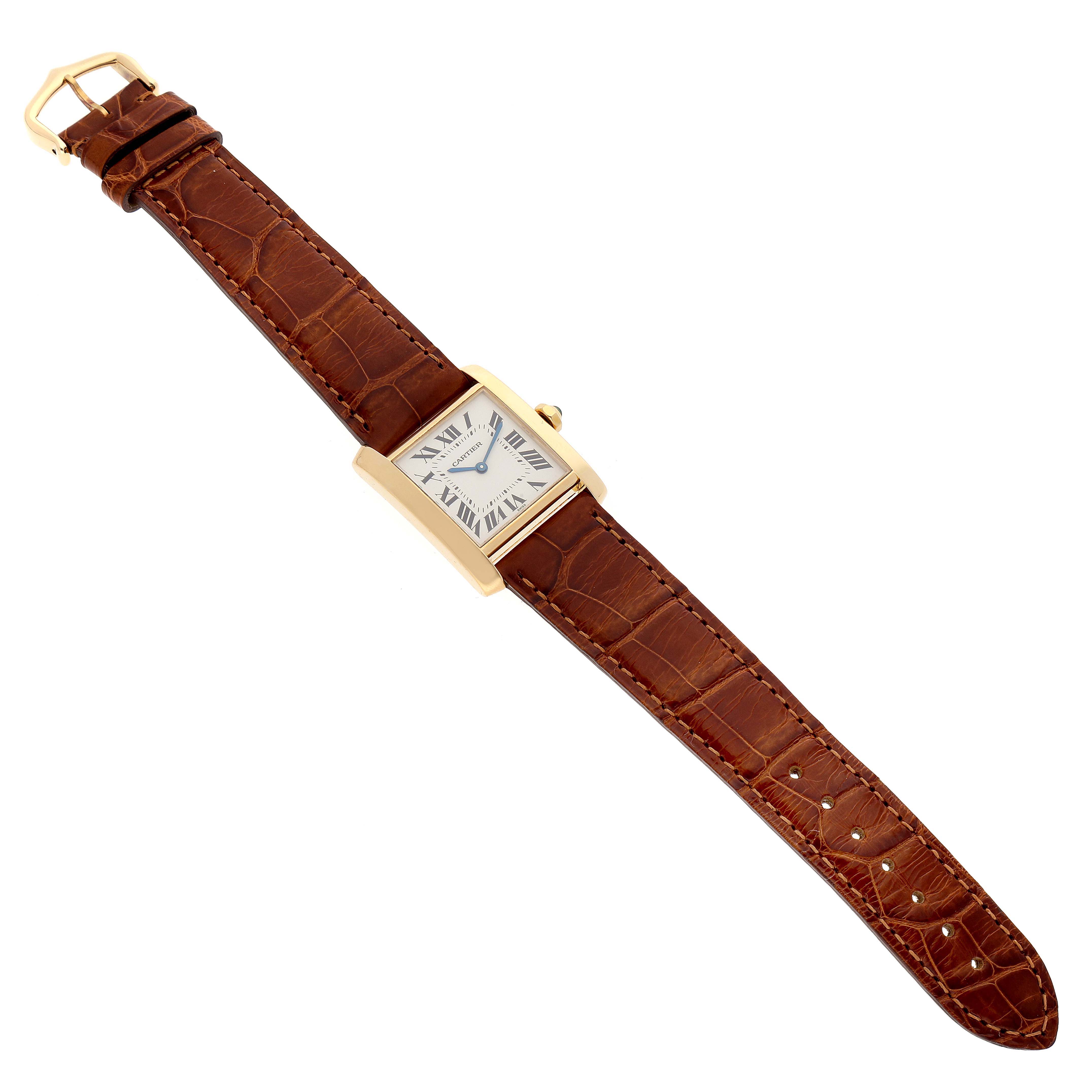 This image shows a full view of a Cartier Tank Française watch with a brown leather strap and rectangular gold case, displayed flat.