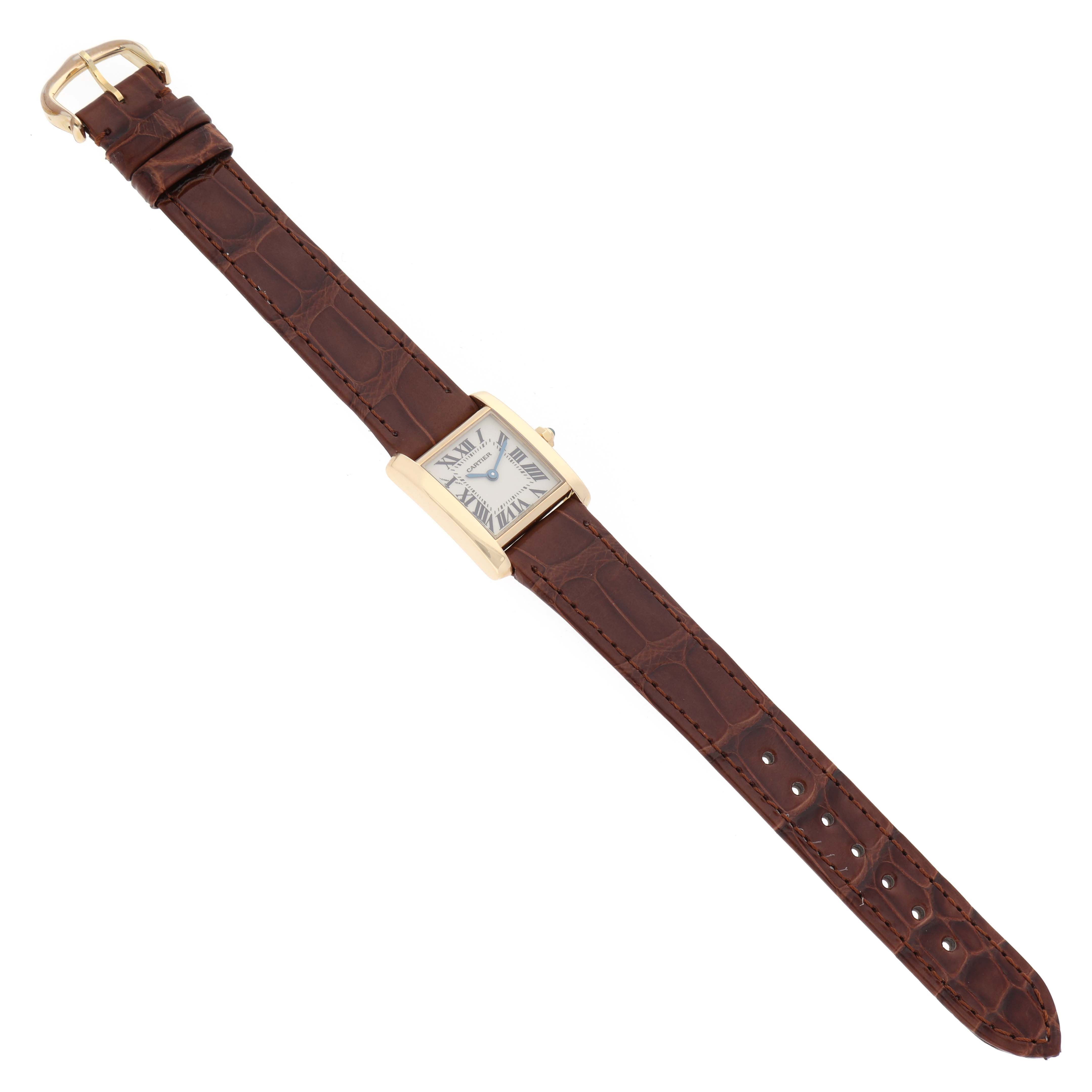 The Cartier Tank Francaise W5000256 Women's Yellow Gold Silver Dial W5000256 Women's Yellow Gold Silver Dial watch is shown from a top view, displaying the face, brown leather strap, and gold buckle.