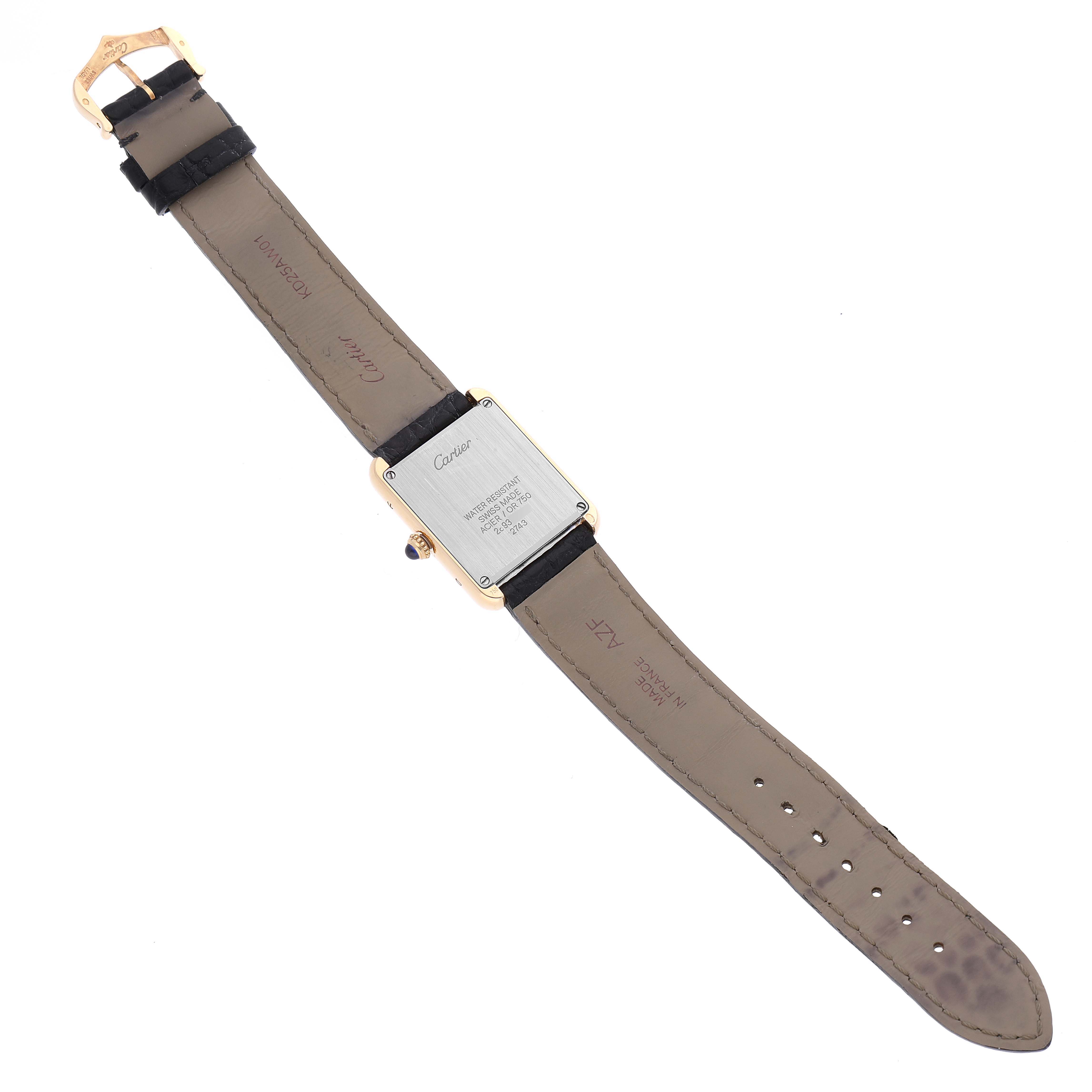 The image shows the back of a Cartier Tank Solo W1018755 Women's Yellow Gold Silver Dial W1018755 Women's Yellow Gold Silver Dial watch and its brown leather strap fully extended, displaying its buckle, casing, and markings.