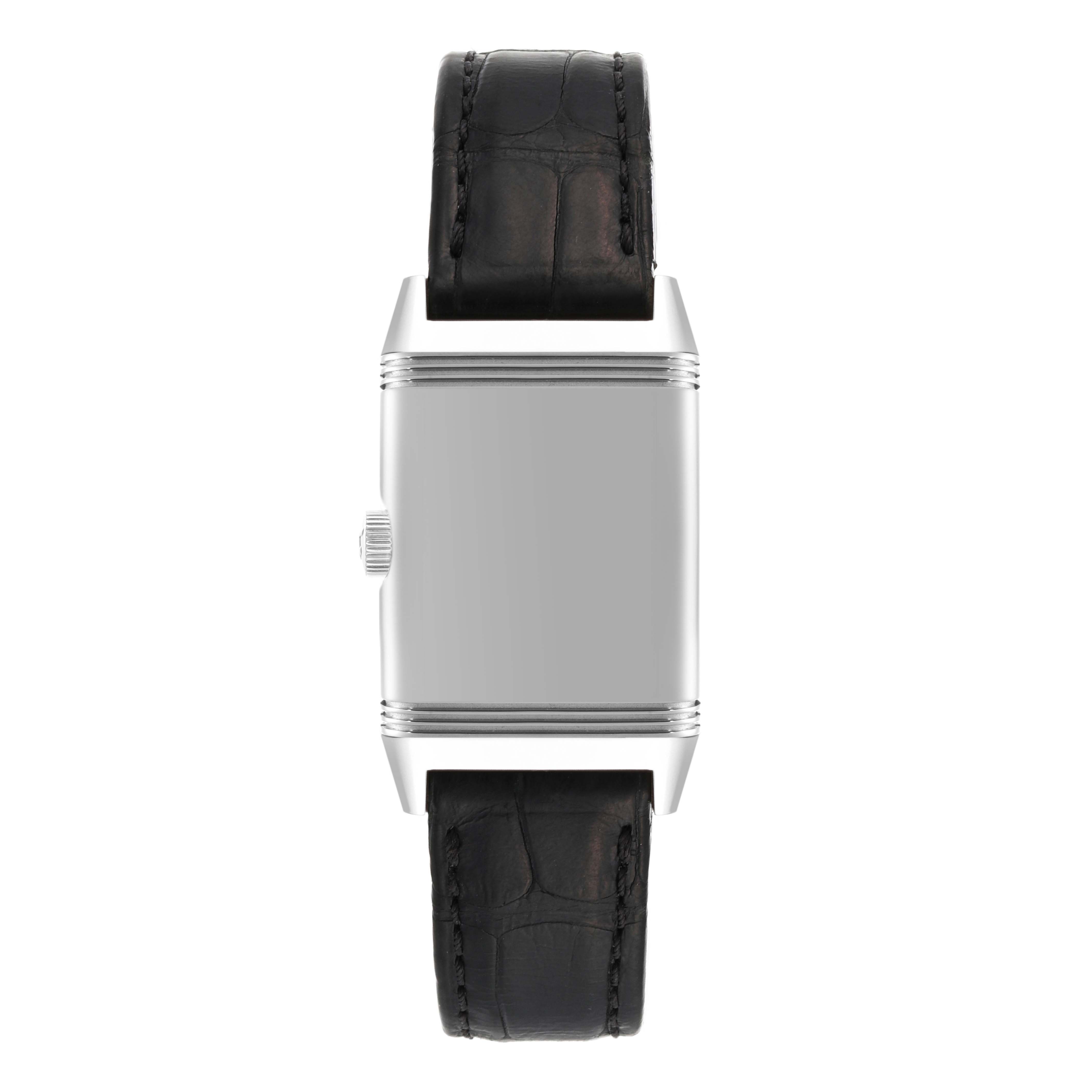 The image shows a front view of the Jaeger-LeCoultre Reverso watch, focusing on its case, crown, and black leather strap.