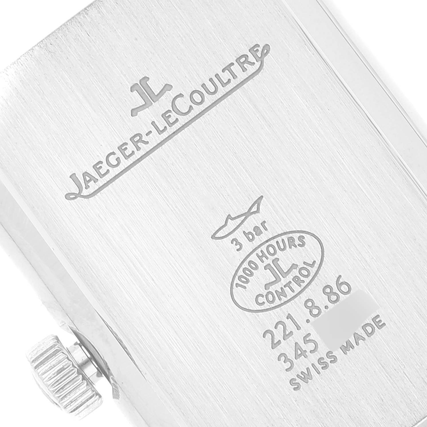 This close-up shows the back case of a Jaeger-LeCoultre Reverso watch, highlighting the engravings and crown.