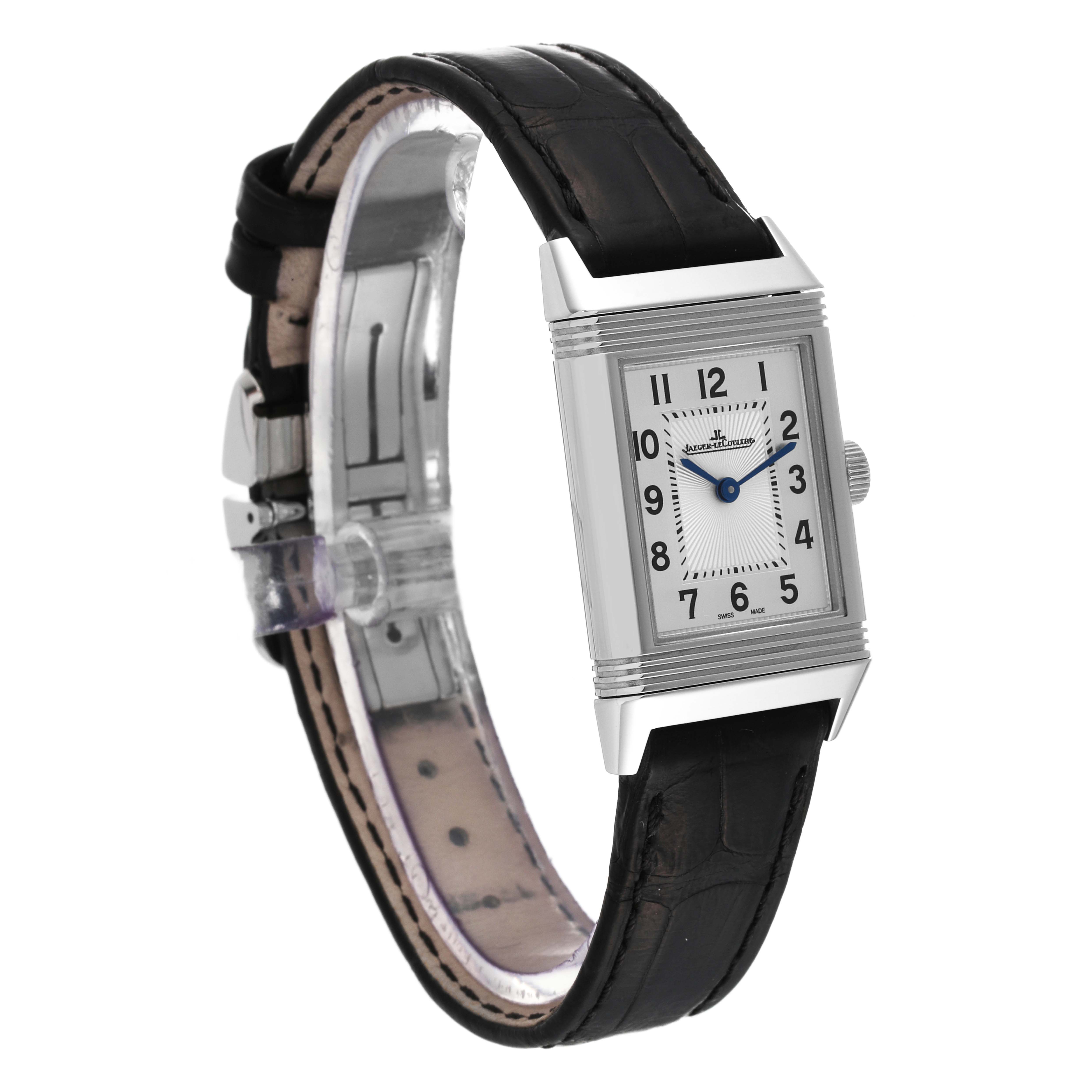 The image shows a side and front angle of the Jaeger-LeCoultre Reverso watch highlighting its rectangular face and black leather strap.