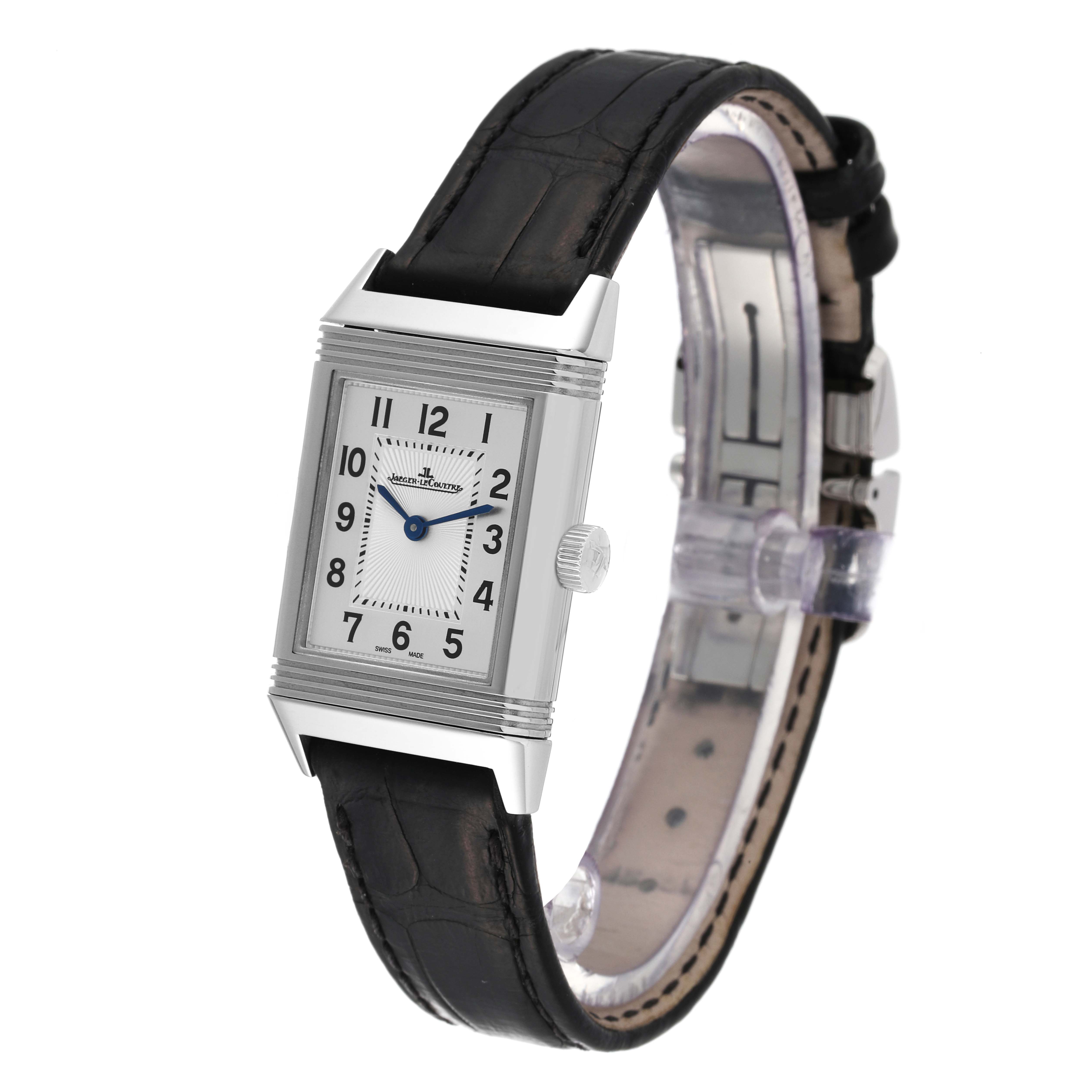 The image shows a Jaeger-LeCoultre Reverso watch from a front angle, highlighting the rectangular case, dial, crown, and leather strap.