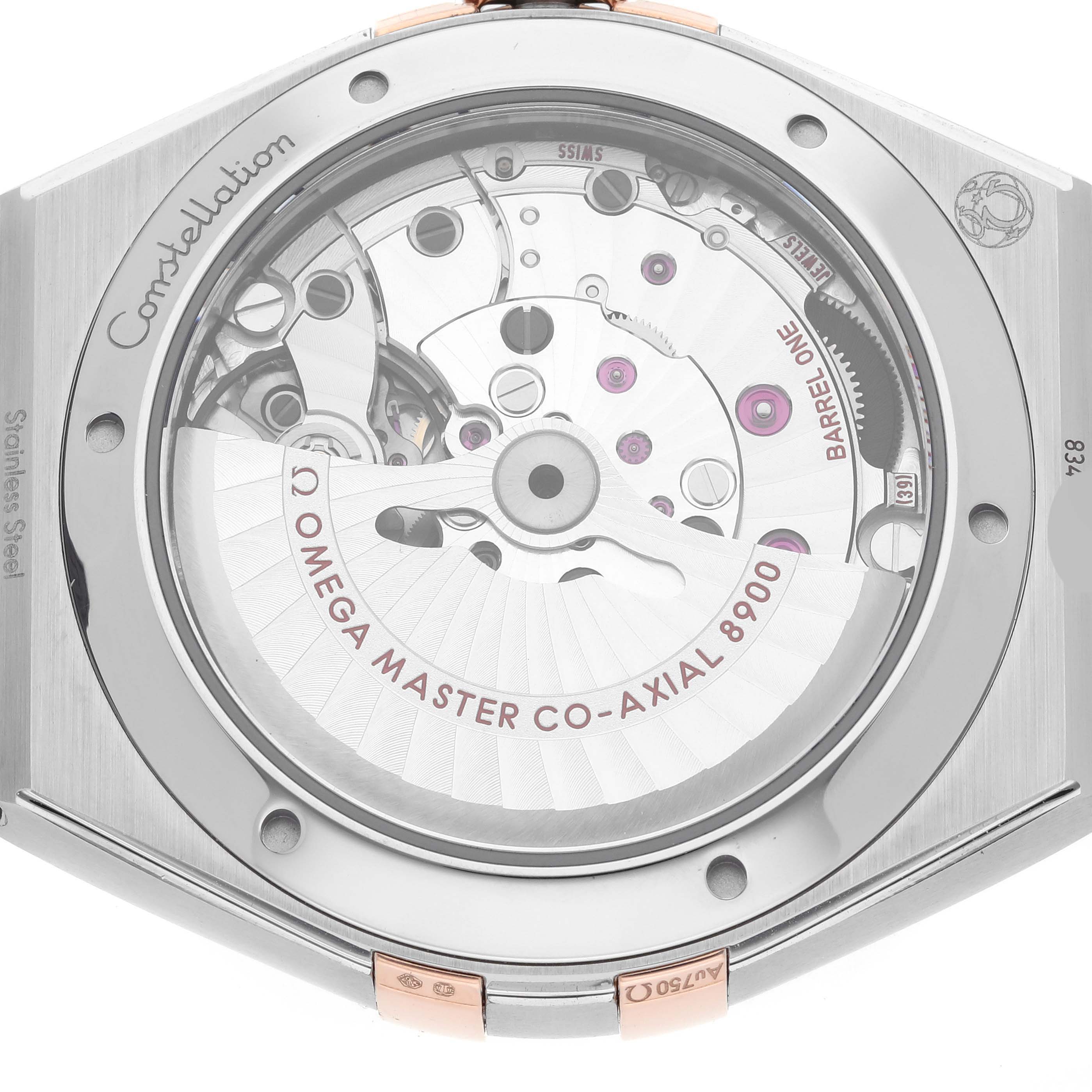The image shows the back view of an Omega Constellation 131.23.41.21.06.001 Men's Steel and Gold (two tone) Silver Dial 131.23.41.21.06.001 Men's Steel and Gold (two tone) Silver Dial watch, highlighting its Co-Axial 8900 movement.
