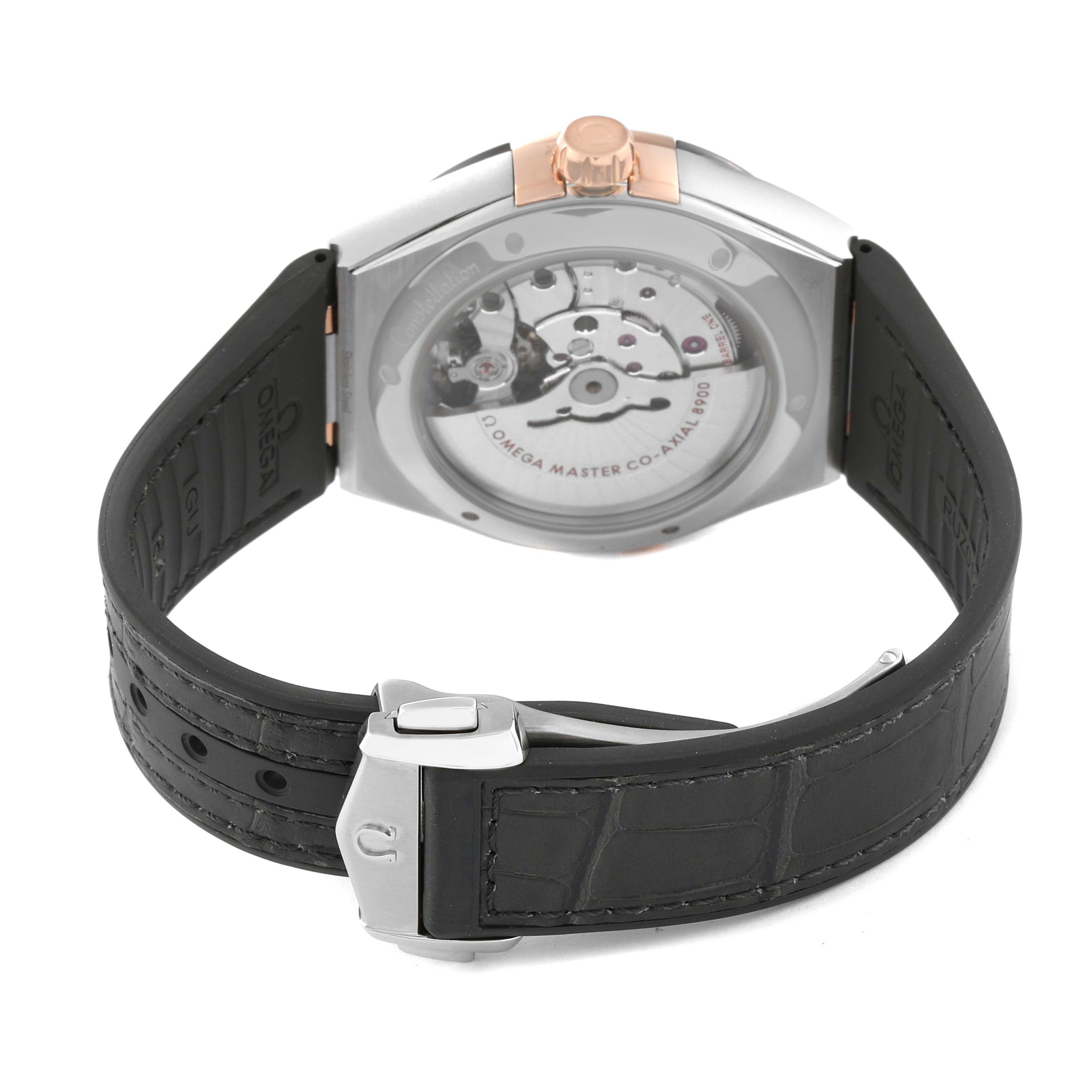 The image shows the back view of an Omega Constellation 131.23.41.21.06.001 Men's Steel and Gold (two tone) Silver Dial 131.23.41.21.06.001 Men's Steel and Gold (two tone) Silver Dial watch displaying its inner mechanisms and leather strap.