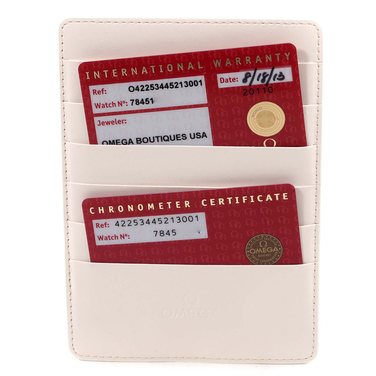 The image shows an Omega De Ville 422.53.44.52.13.001 Men's Rose Gold Black Dial 422.53.44.52.13.001 Men's Rose Gold Black Dial international warranty and chronometer certificate cards in a white cardholder.