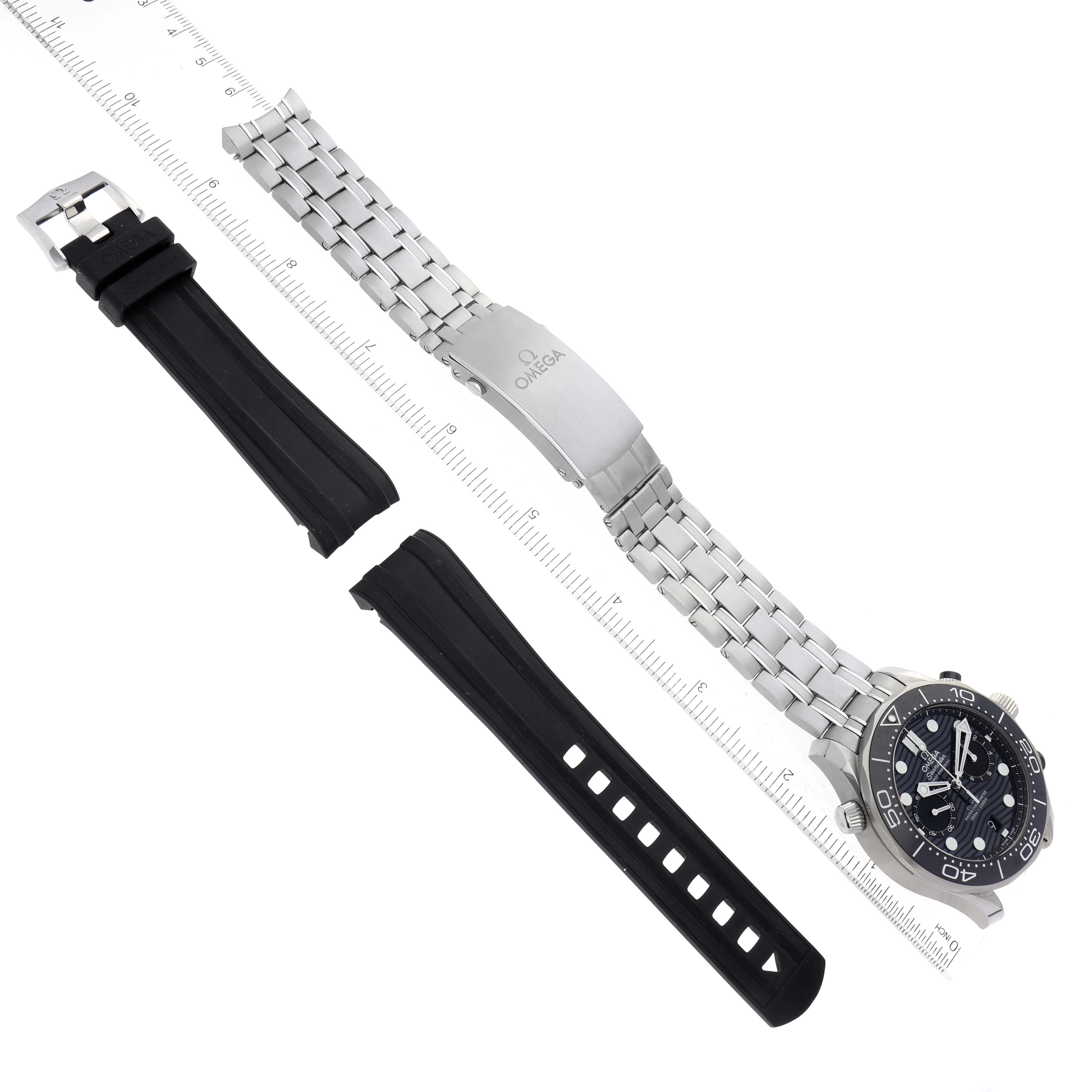 The image shows an Omega Seamaster 210.30.44.51.01.001 Men's Stainless Steel Black Dial 210.30.44.51.01.001 Men's Stainless Steel Black Dial watch with a metal bracelet and an extra black rubber strap, both placed next to a ruler for scale.