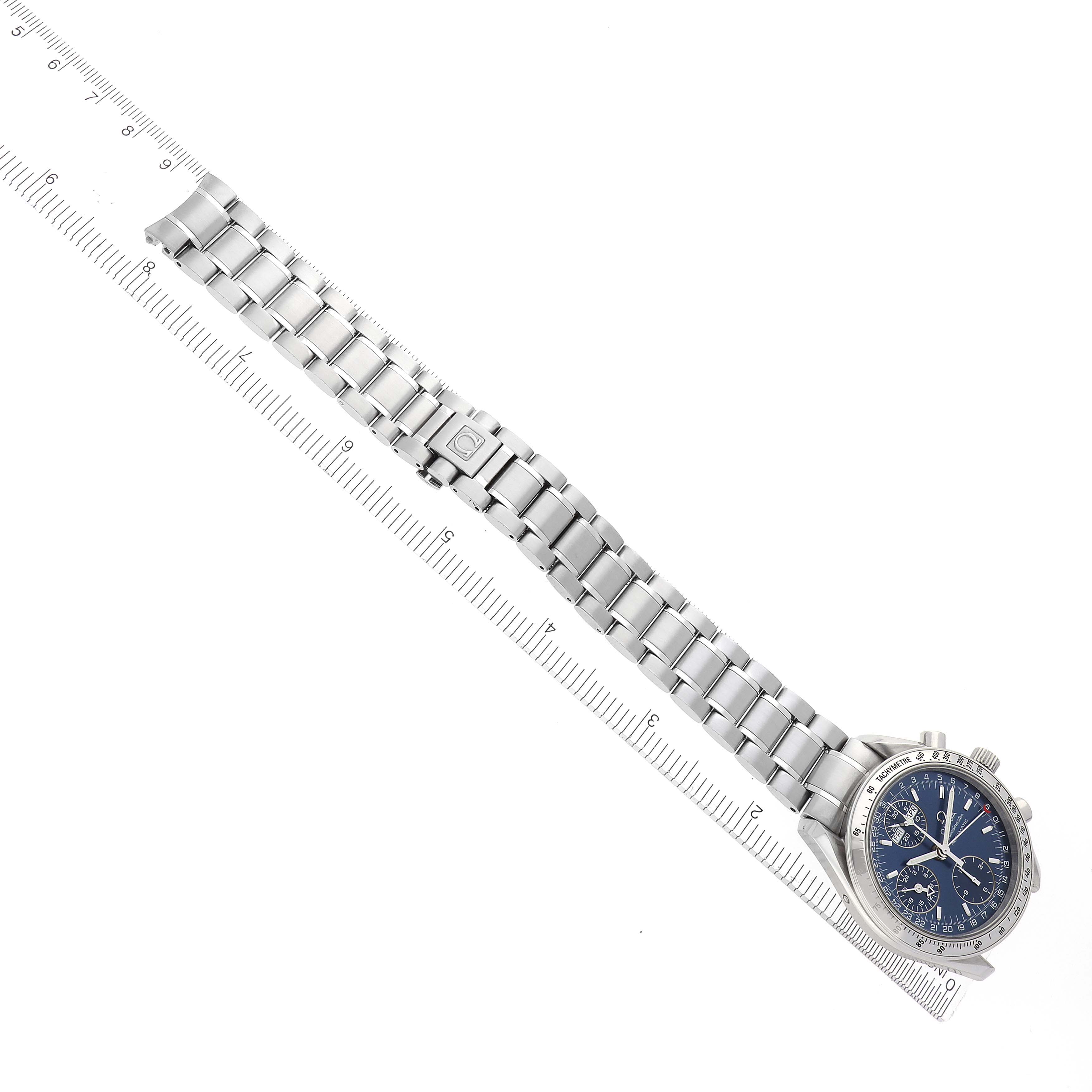 The Omega Speedmaster 3523.80.00 Men
s Stainless Steel Blue Dial 3523.80.00 Men
s Stainless Steel Blue Dial watch is shown from a top-down angle, highlighting its face and stainless steel bracelet alongside a ruler.