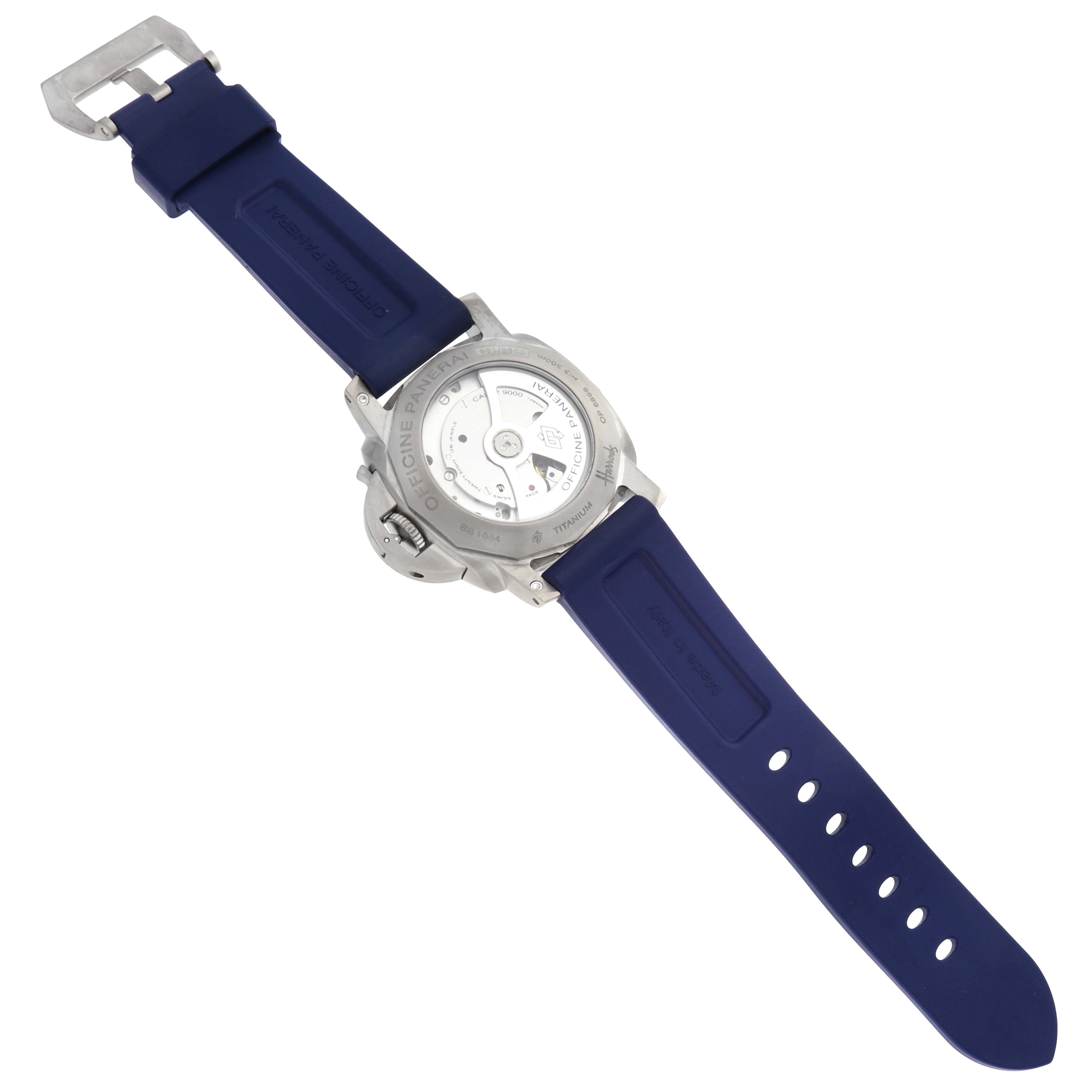 The Panerai Luminor PAM00745 Men's Titanium Blue Dial PAM00745 Men's Titanium Blue Dial watch is shown from the back, displaying its movement and blue strap.