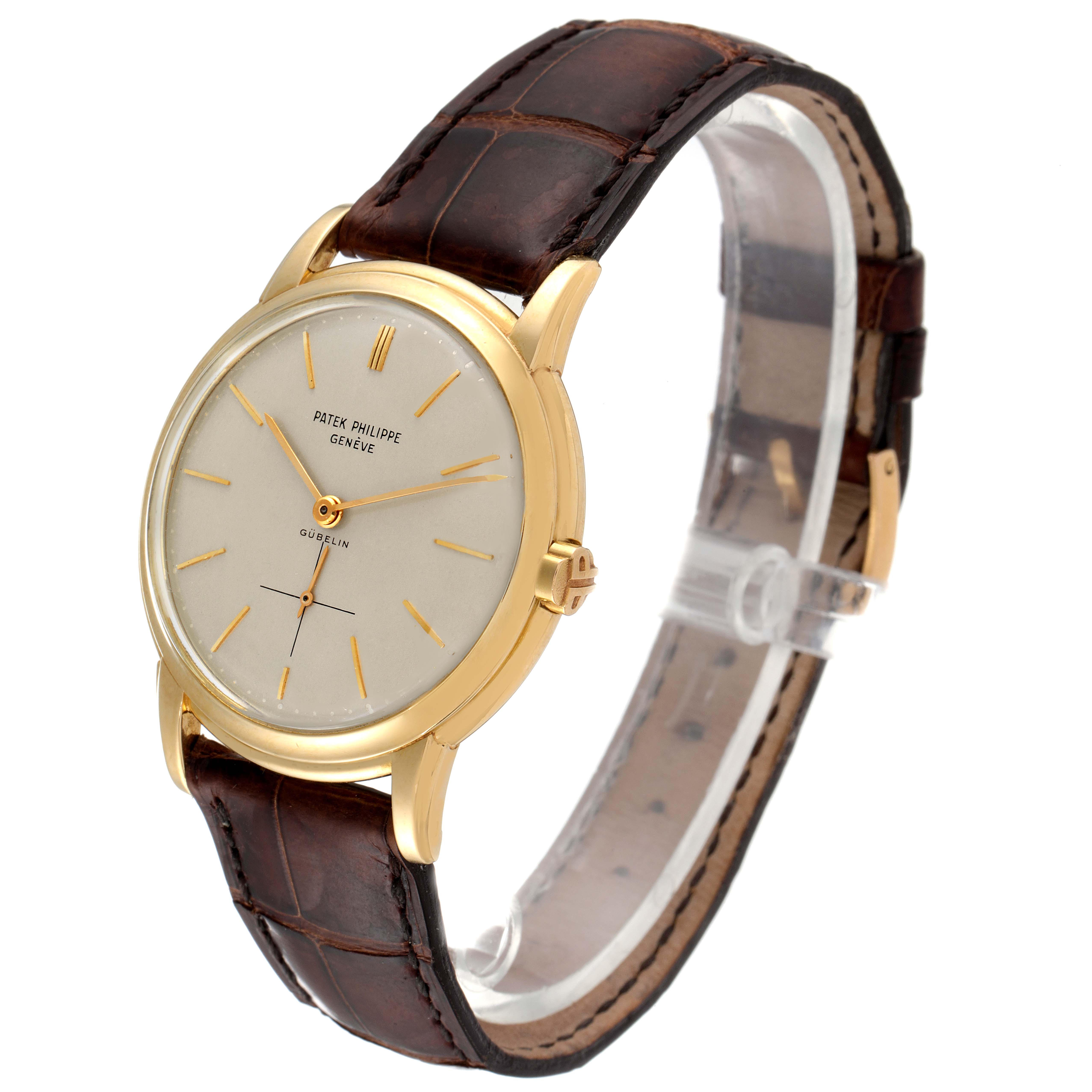 The image shows a Patek Philippe Calatrava 2551J Men's Yellow Gold Silver Dial 2551J Men's Yellow Gold Silver Dial watch from a front-side angle, displaying the dial, case, and leather strap.
