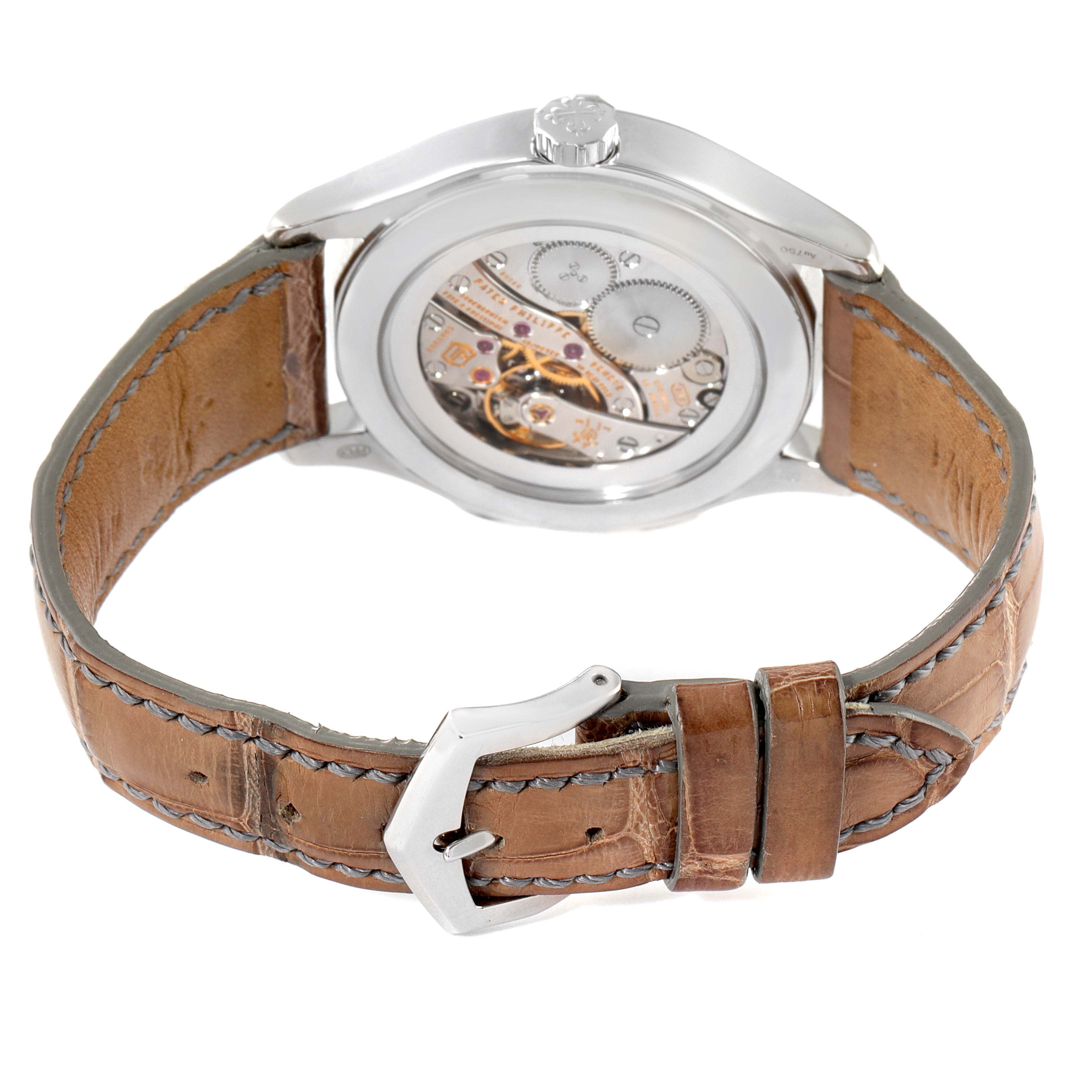 The image shows the back angle of a Patek Philippe Calatrava 7134G-001 Men's White Gold Brown Dial 7134G-001 Men's White Gold Brown Dial watch, focusing on the movement and the brown leather strap with its buckle.