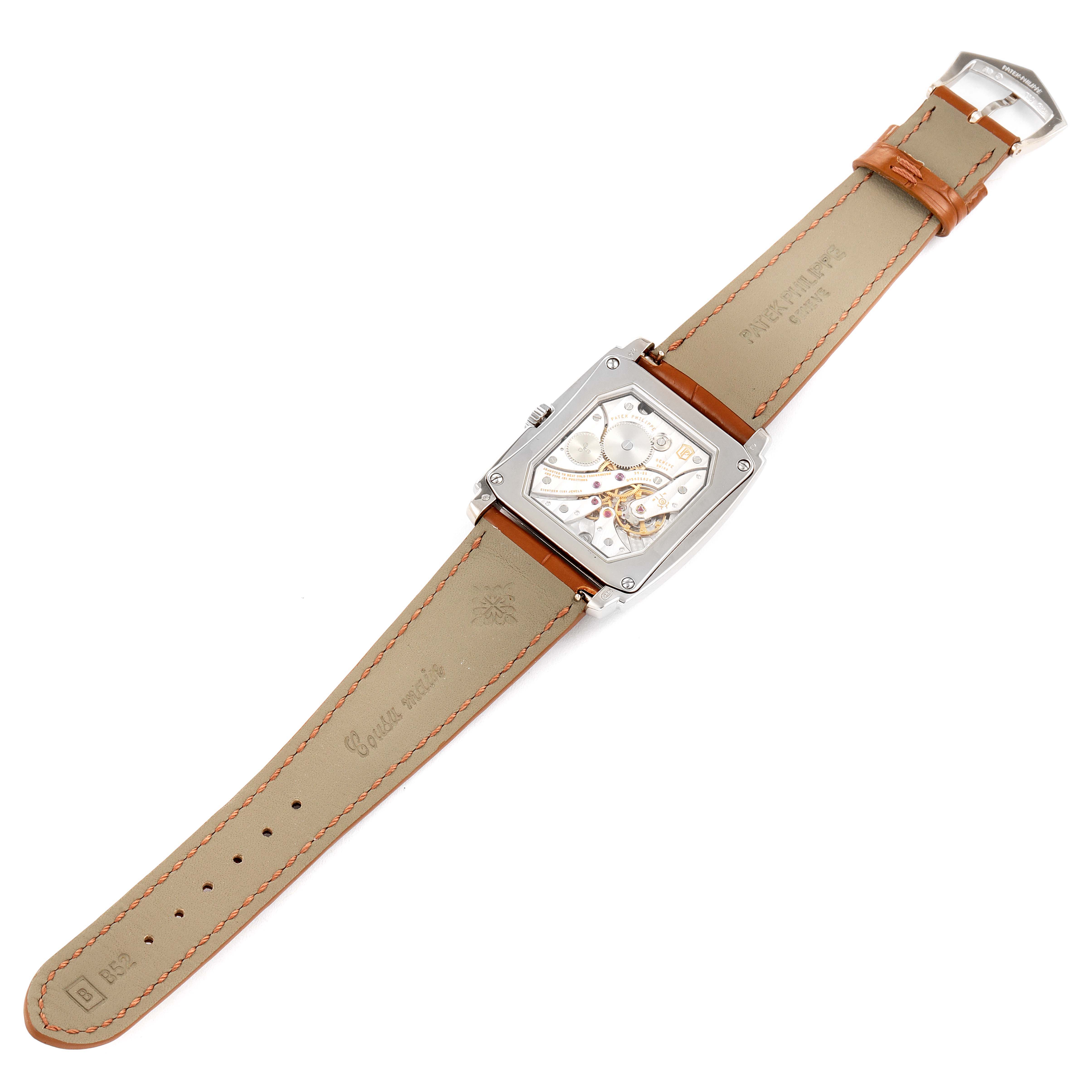 This image shows the backside of the Patek Philippe Gondolo 5124G-001 Men's White Gold Pink Dial 5124G-001 Men's White Gold Pink Dial watch, displaying its inner mechanism and leather straps.