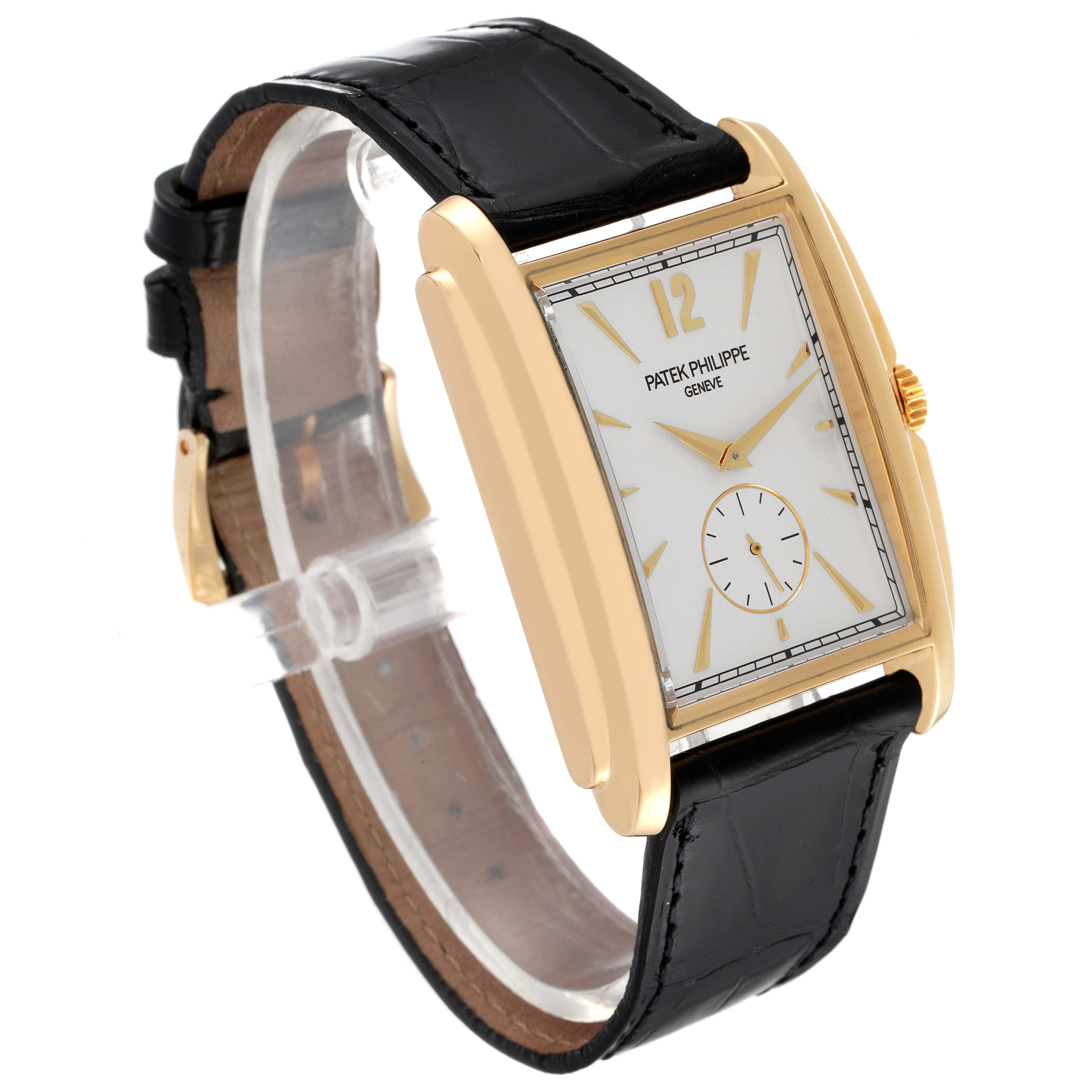 The image shows a side view of a Patek Philippe Gondolo 5124J Men's Yellow Gold Silver Dial 5124J Men's Yellow Gold Silver Dial watch, highlighting its rectangular gold case, white dial, and black leather strap.