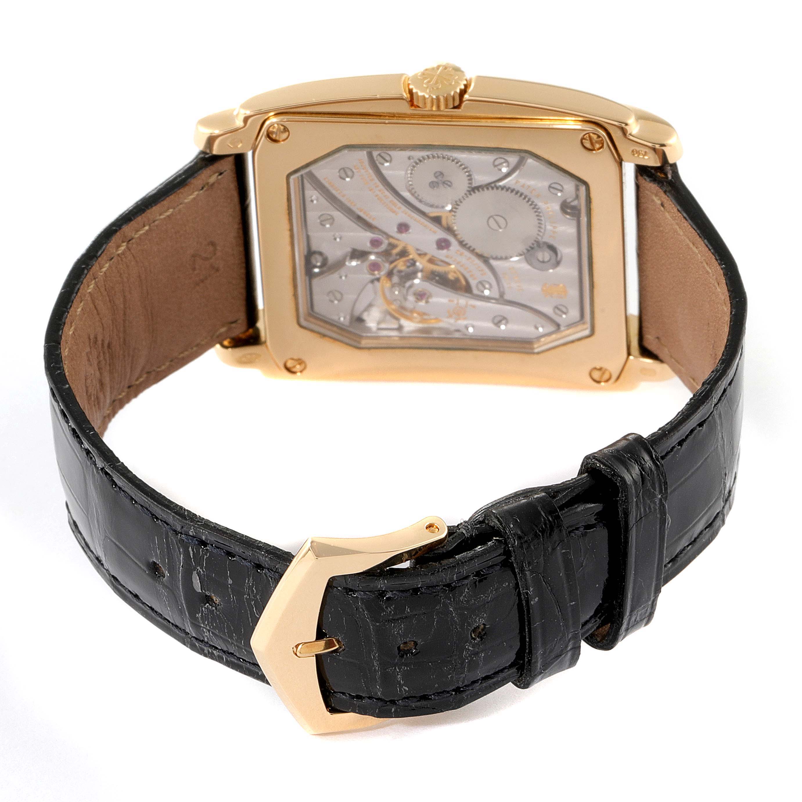 The image shows the back view of a Patek Philippe Gondolo 5124J Men's Yellow Gold Silver Dial 5124J Men's Yellow Gold Silver Dial watch, highlighting its mechanical movement and leather strap.