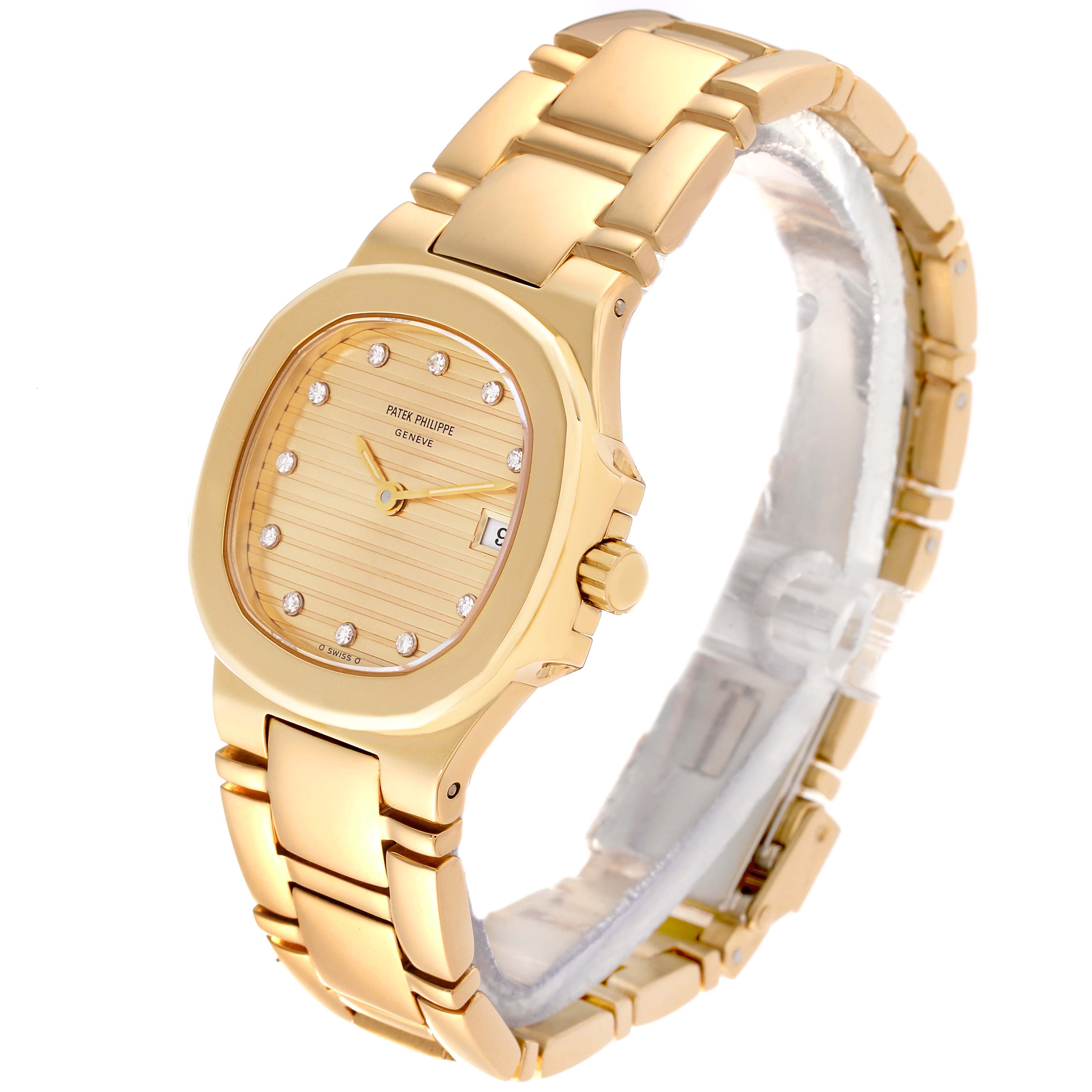The Patek Philippe Nautilus 4700/51 Women's Yellow Gold Champagne Dial 4700/51 Women's Yellow Gold Champagne Dial watch is shown at an angle displaying its gold bracelet, case, dial with diamond indices, and date window.