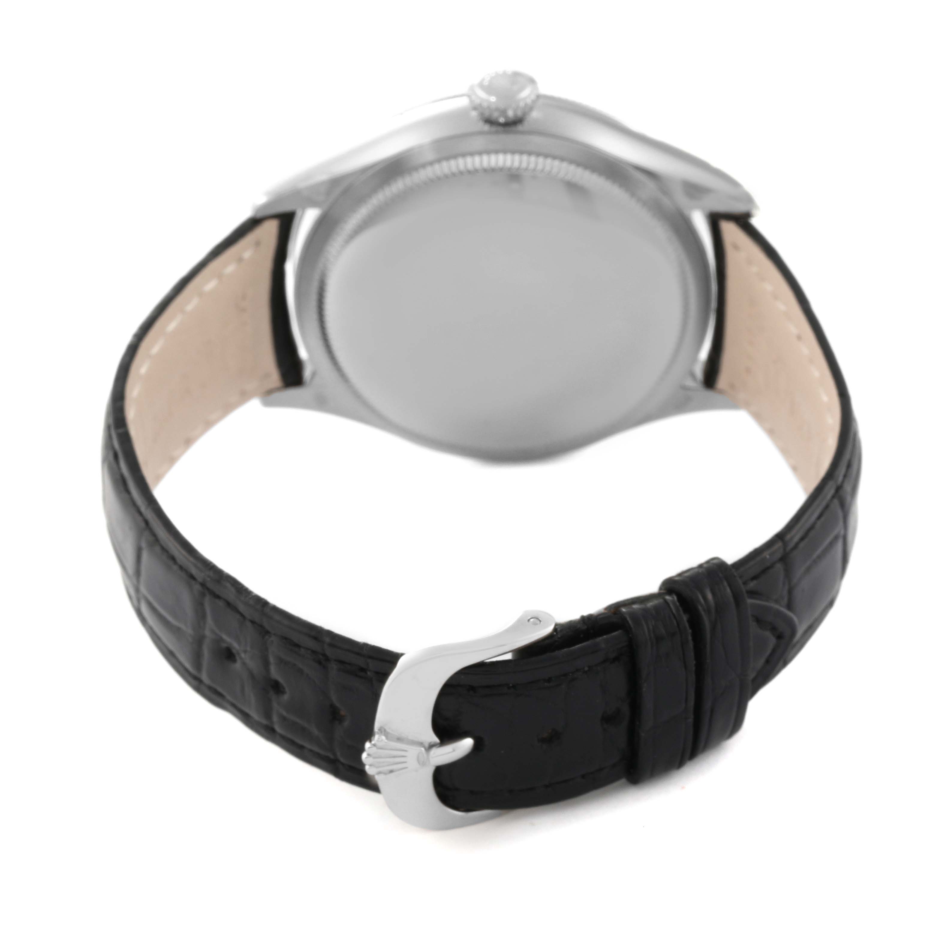 The image shows a rear view of a Rolex Cellini 50609RBR Men's White Gold Black Dial 50609RBR Men's White Gold Black Dial watch, highlighting the back of the case and the leather strap with the clasp.