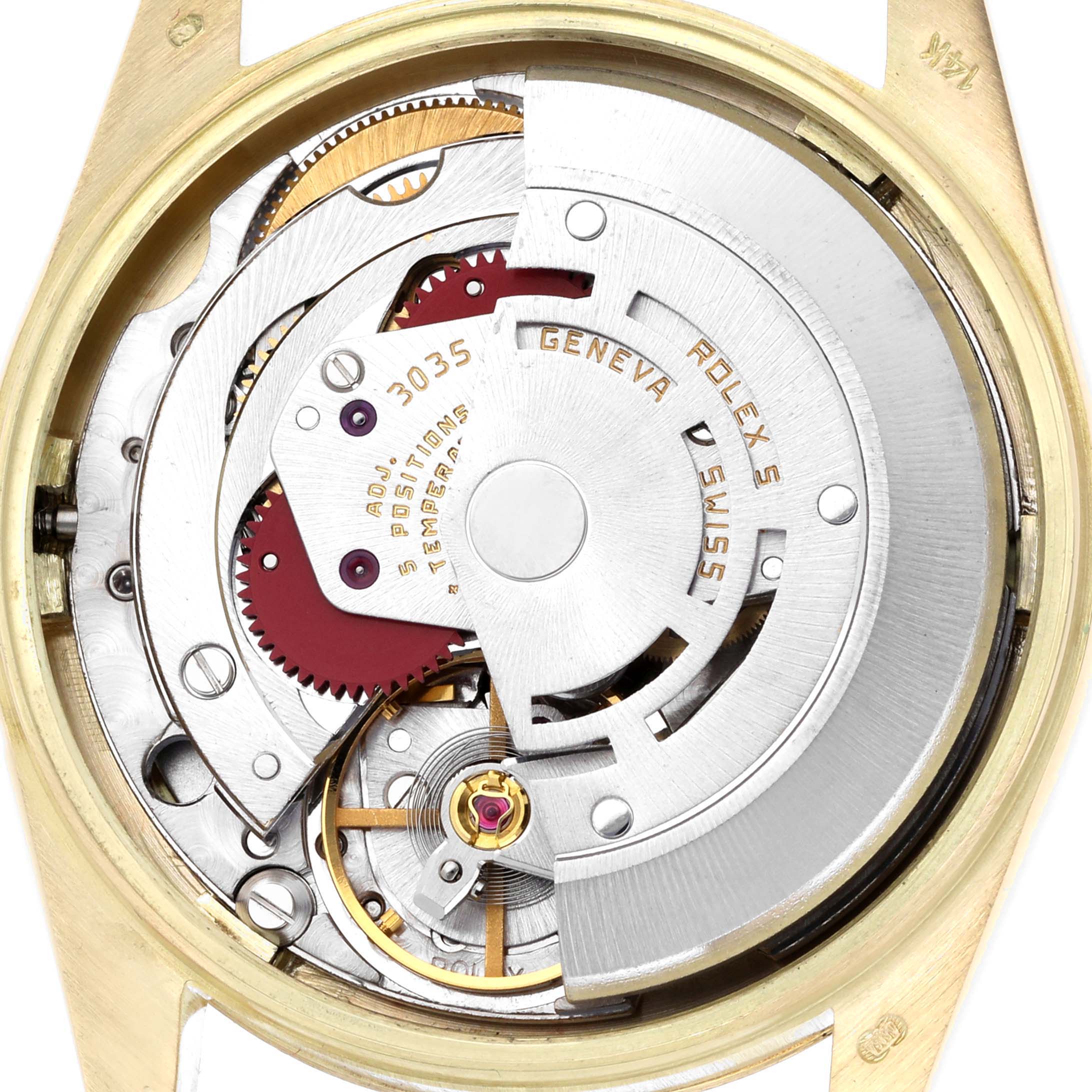 The image shows an angled view of the Rolex Date 15037 Men
s Yellow Gold Champagne Dial 15037 Men
s Yellow Gold Champagne Dial watch movement, highlighting gears and the rotor mechanism.