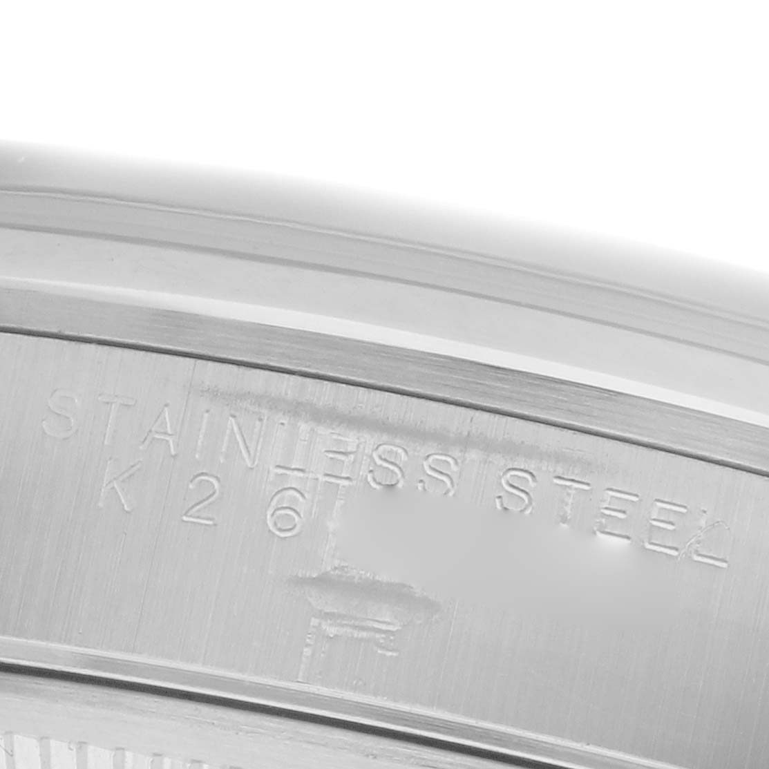 The image shows a close-up of the side of the Rolex Date 15200 Men's Stainless Steel Black Dial 15200 Men's Stainless Steel Black Dial model, featuring engraved text on its stainless steel surface.