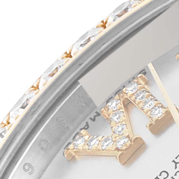 This close-up image shows part of the bezel and dial of a Rolex Mid-Size 178383 Women
s Steel and Gold (two tone) Silver Dial 178383 Women
s Steel and Gold (two tone) Silver Dial watch, featuring diamond accents.