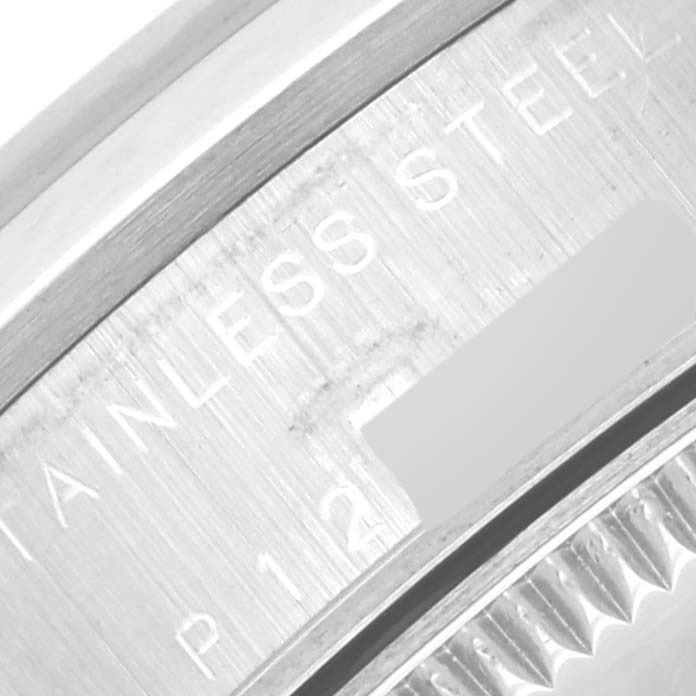 The image shows a close-up of the stainless steel case back of a Mid-Size Rolex watch.