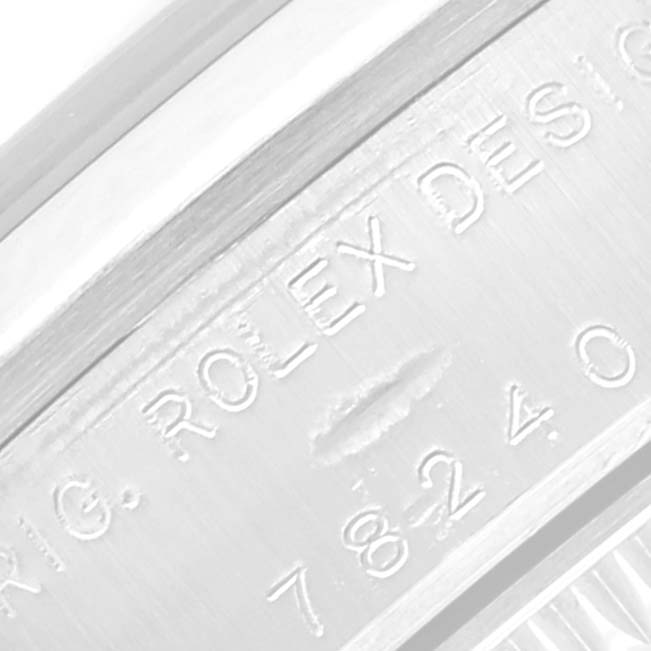 The image shows a close-up of the engraved logo and numbers on the side of a Rolex Mid-Size 78240 Women's Stainless Steel Silver Dial 78240 Women's Stainless Steel Silver Dial model watch.