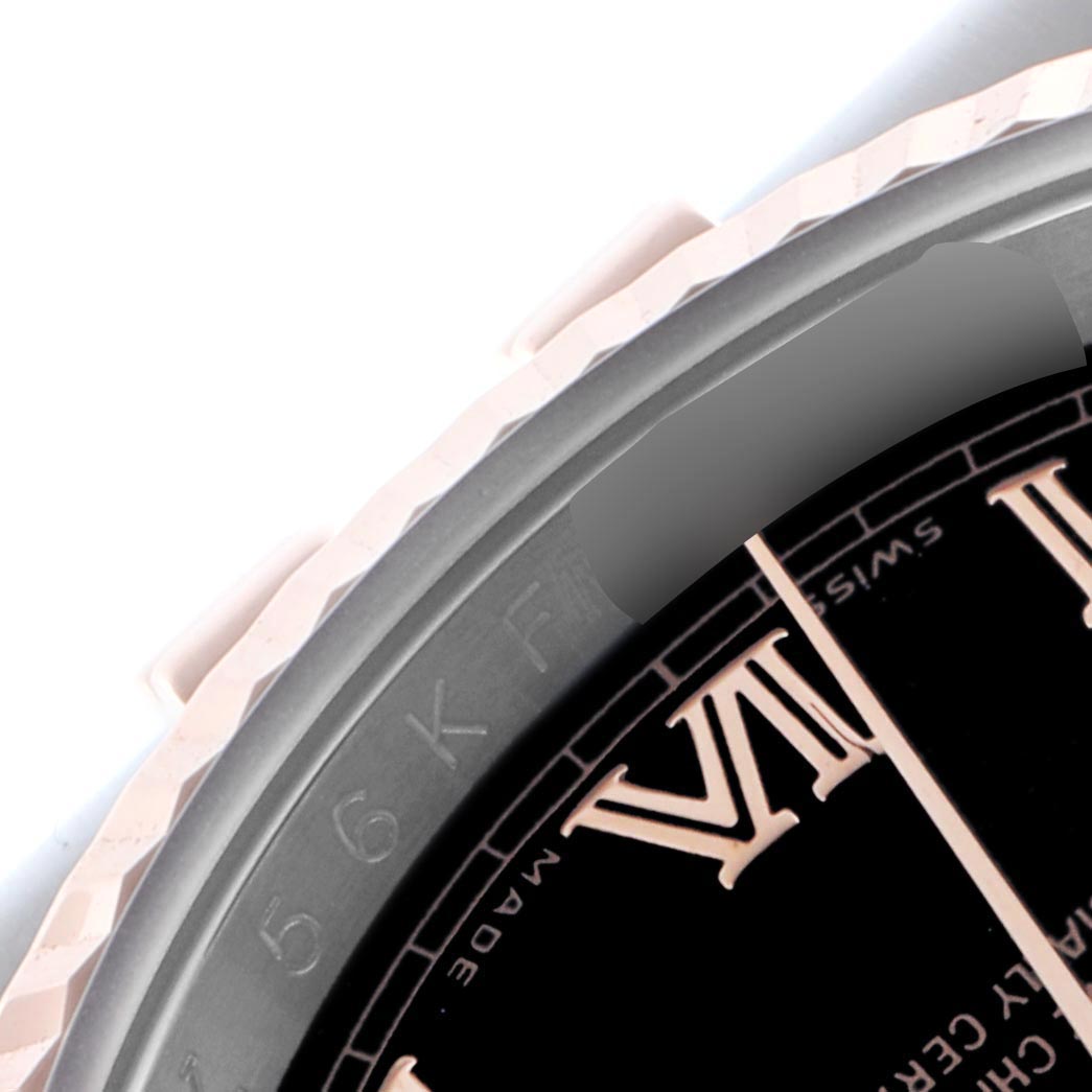 The image shows a close-up of the Rolex Datejust 116231 Men's Steel and Gold (two tone) Black Dial 116231 Men's Steel and Gold (two tone) Black Dial bezel and part of the dial with Roman numerals.