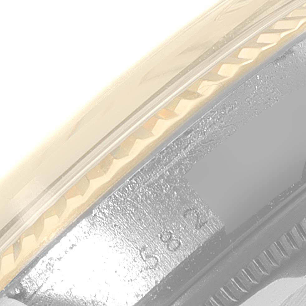 The image shows a close-up of the bezel and part of the case of a Rolex Vintage Collection 16013 Men's Steel and Gold (two tone) Silver Dial 16013 Men's Steel and Gold (two tone) Silver Dial watch.