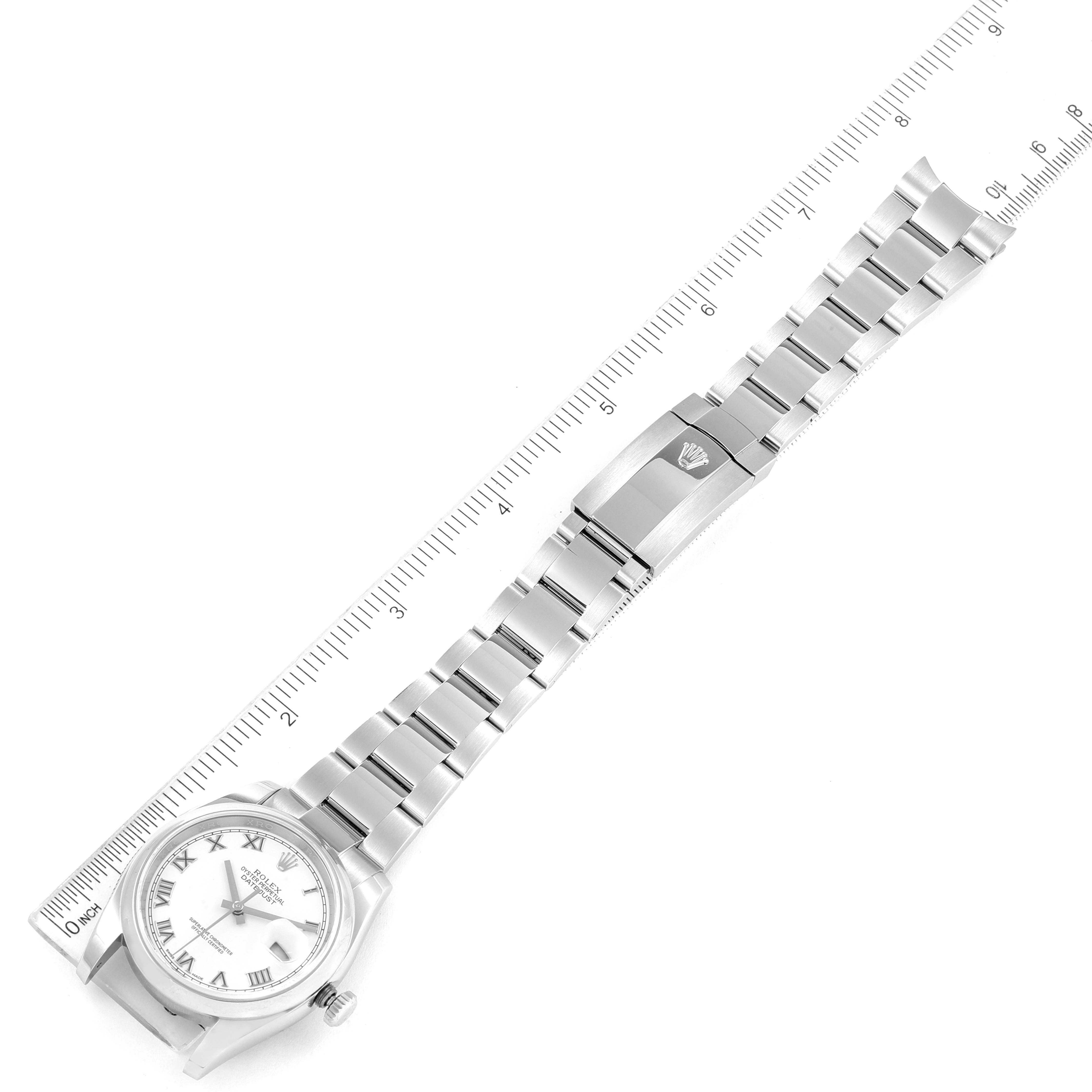 This image shows a Rolex Datejust 116200 Men's Stainless Steel White Dial 116200 Men's Stainless Steel White Dial watch with a stainless steel band laid flat, alongside a ruler for size reference.
