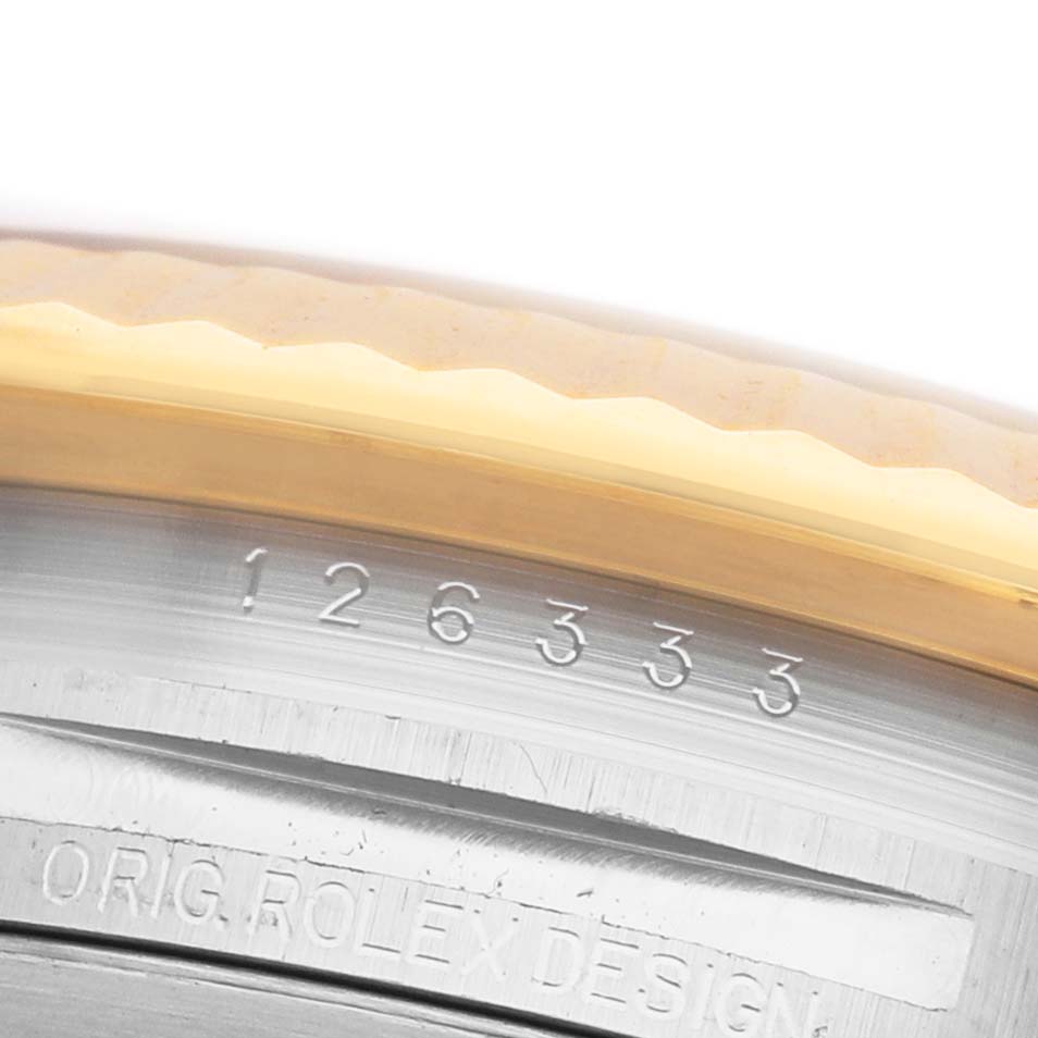 The image shows a close-up of the side of a Rolex Datejust 41 126333 Men's Steel and Gold (two tone) Champagne Dial, highlighting the bezel and engraved case.