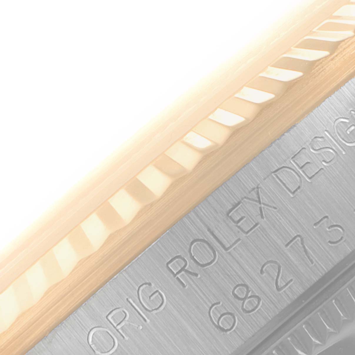 The image shows a close-up of the case side and fluted bezel, with the engraved text on the Mid-Size Rolex watch.