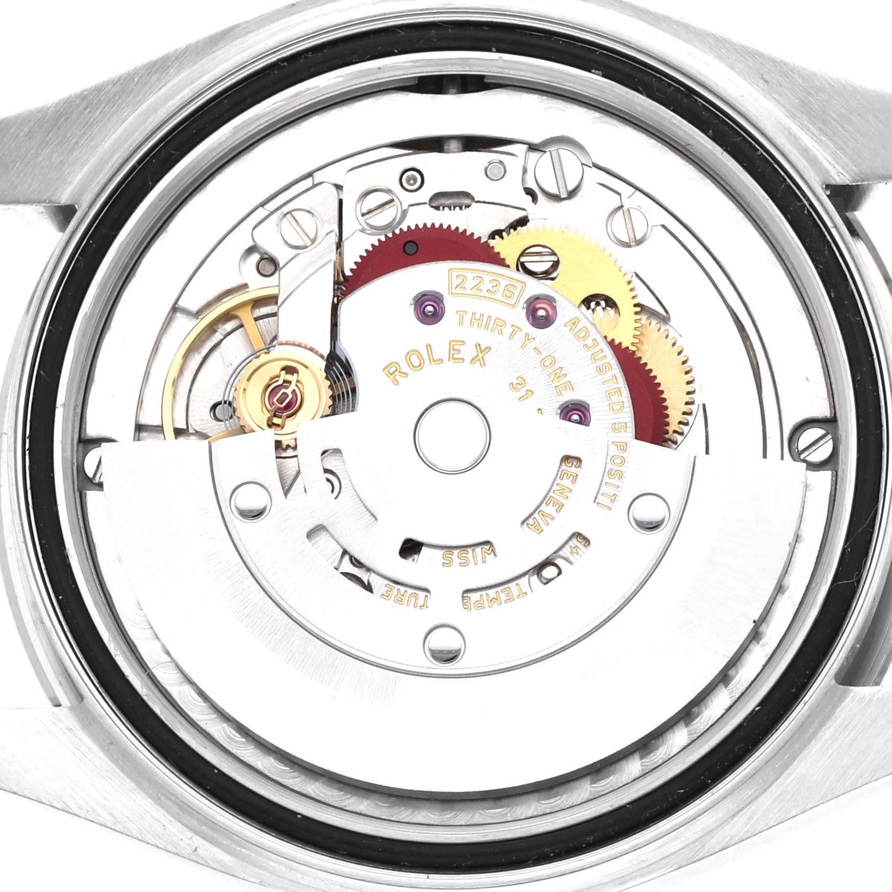 The image shows the movement of a Rolex Mid-Size 278274 Women
s Stainless Steel Blue Dial 278274 Women
s Stainless Steel Blue Dial watch viewed from the back, highlighting gears and engravings.