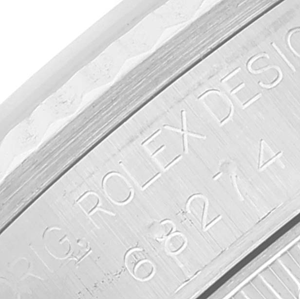 The image shows an engraved part of the casing for a Mid-Size Rolex watch at a close-up angle.
