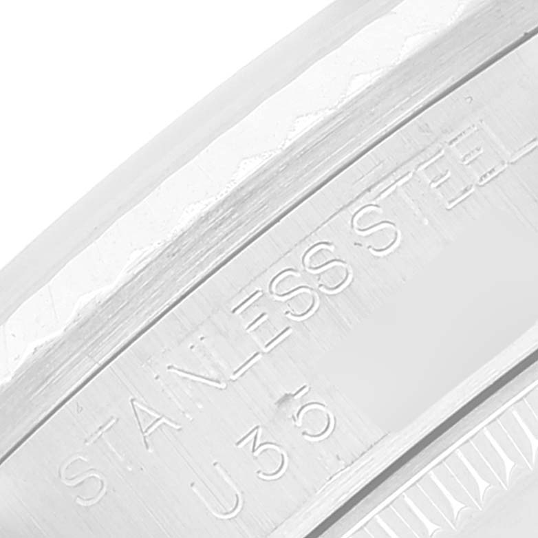 The image shows a close-up angle of the stainless steel case side of a Mid-Size Rolex watch.